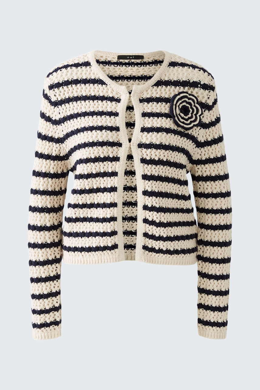 Stylish women's cardigan: A woman in a striped pullover with a round logo, perfect for casual wear.