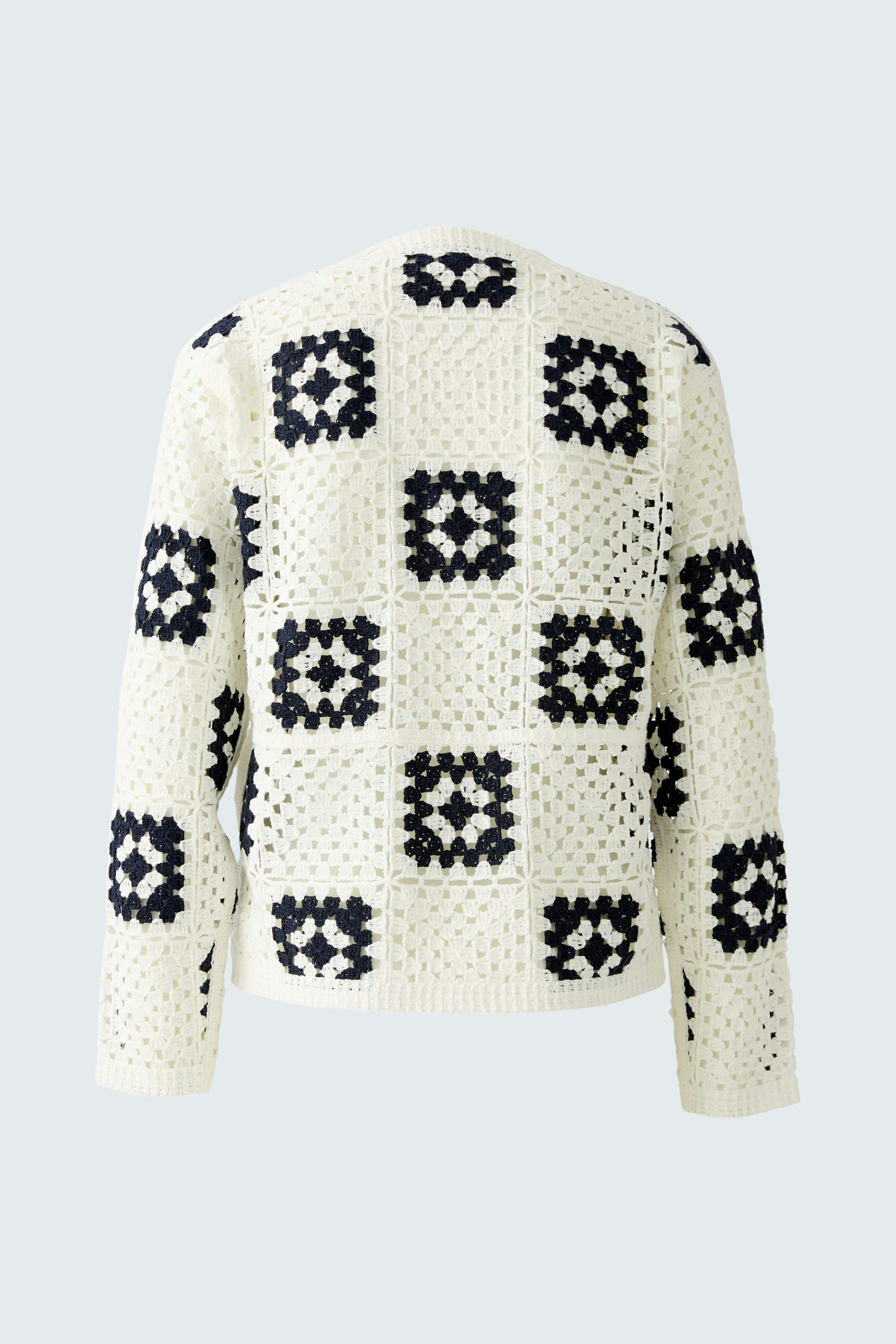 Stylish women's cardigan: A cream pullover with navy square patterns, perfect for layering.