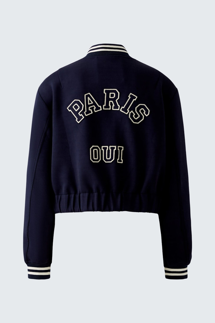 Stylish women's blouson: A navy bomber jacket with 'PARIS OUI' lettering on the back.