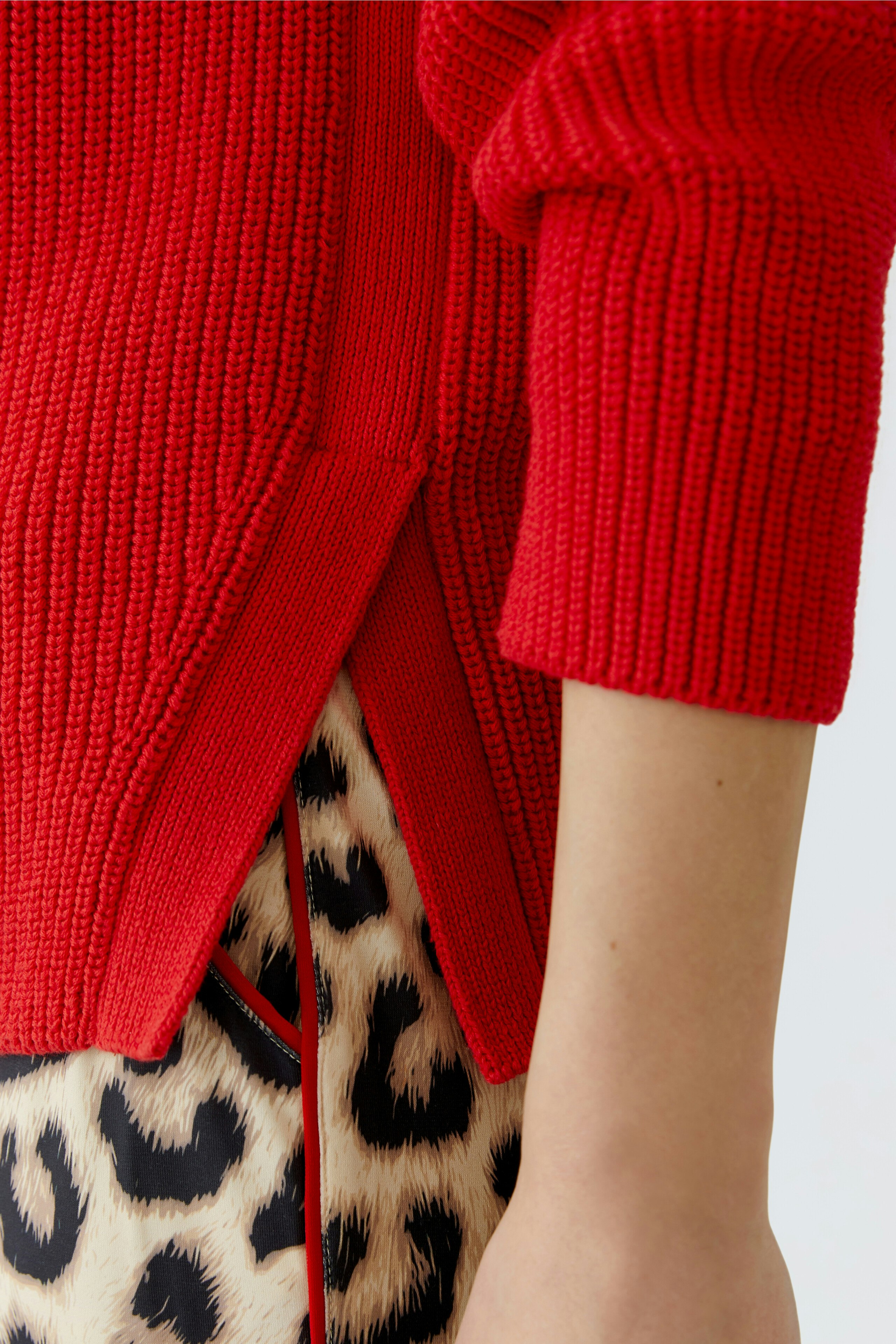 Stylish women's pullover in vibrant red with side slits, perfect for a chic, casual look.