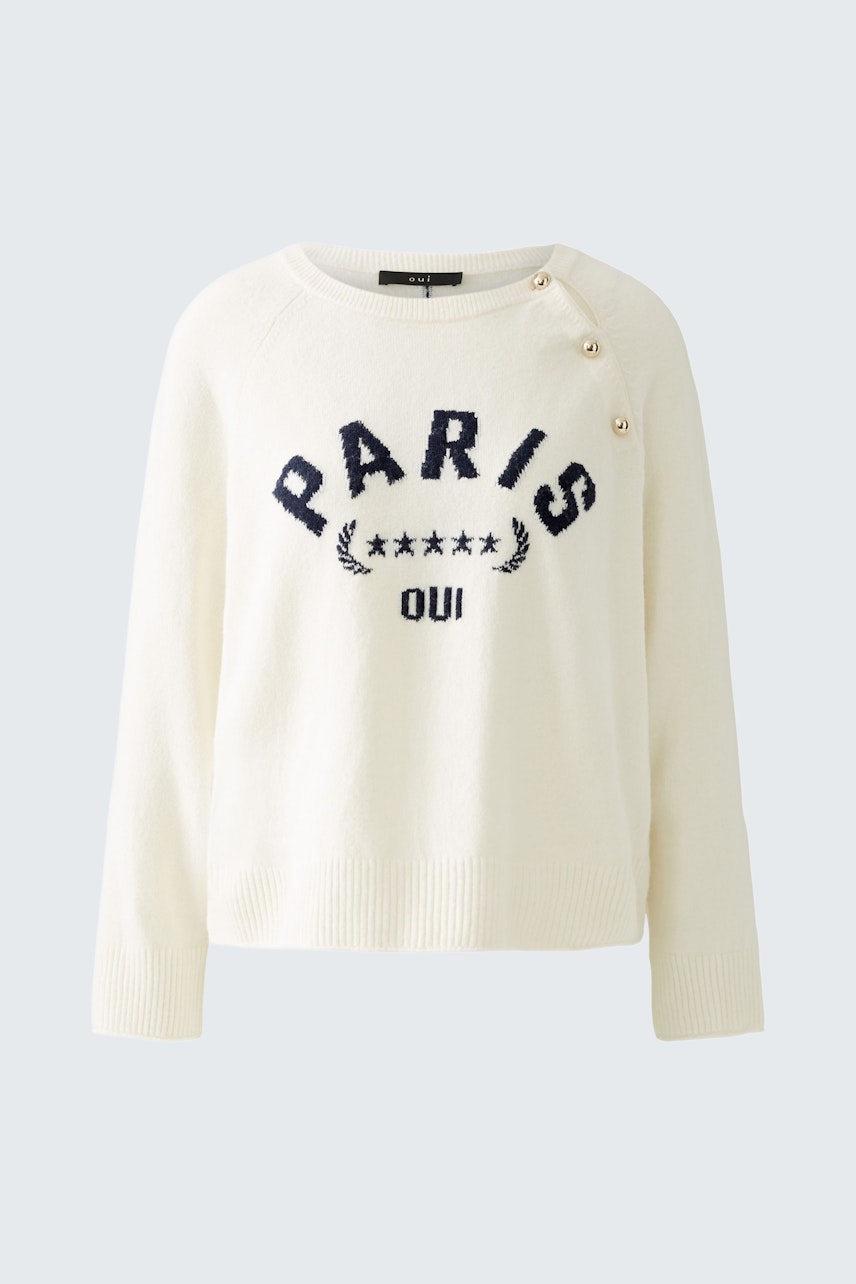 Klassischer Damen-Pullover in Creme mit blauem 'PARIS'-Schriftzug und Knopfdetails.