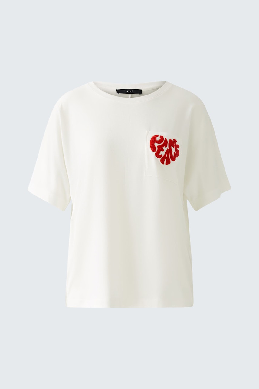 Stylish women's T-shirt: White tee with a red heart design, perfect for casual outfits.