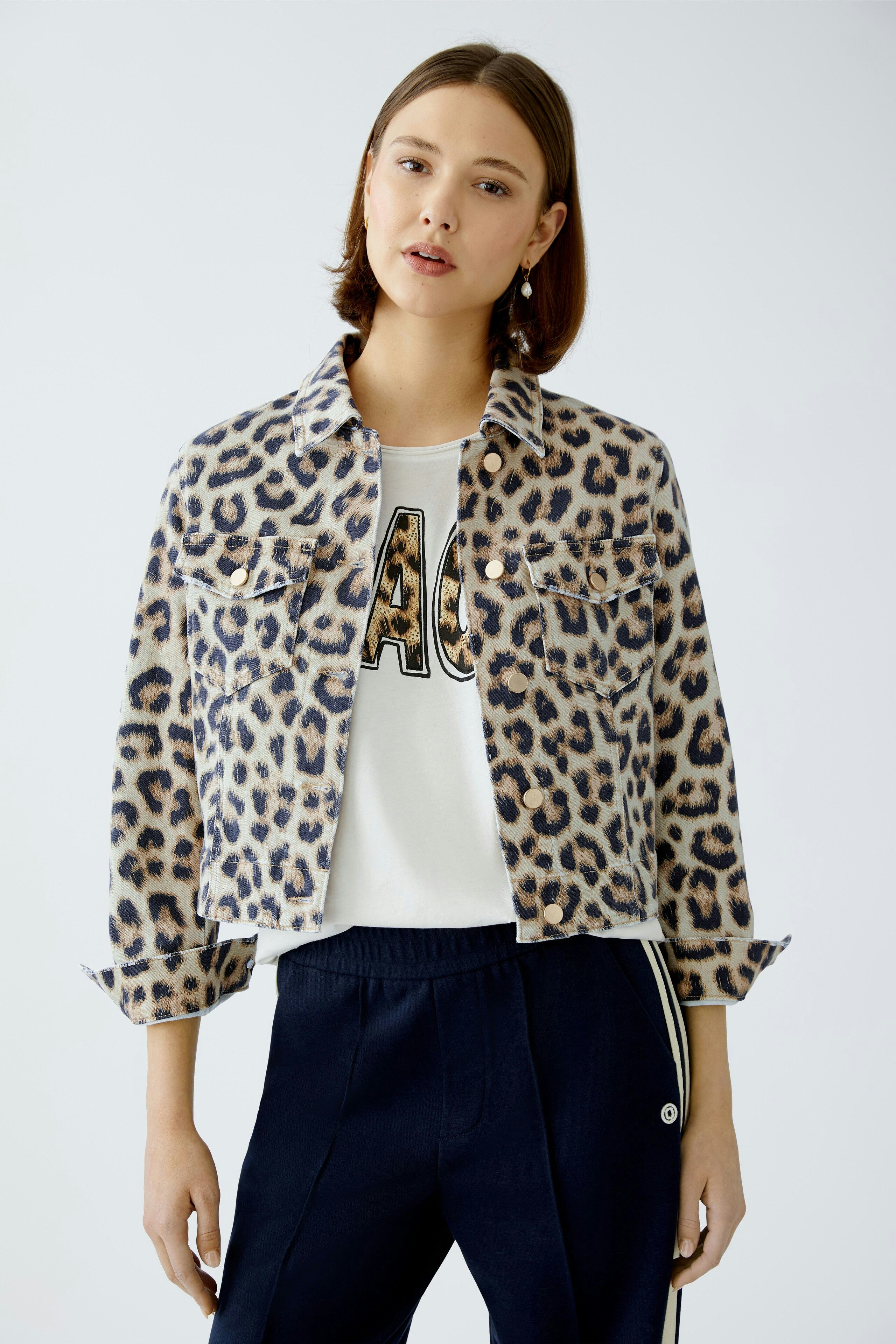 Stylish women's denim jacket with a leopard print, paired with a casual white tee and sporty pants.