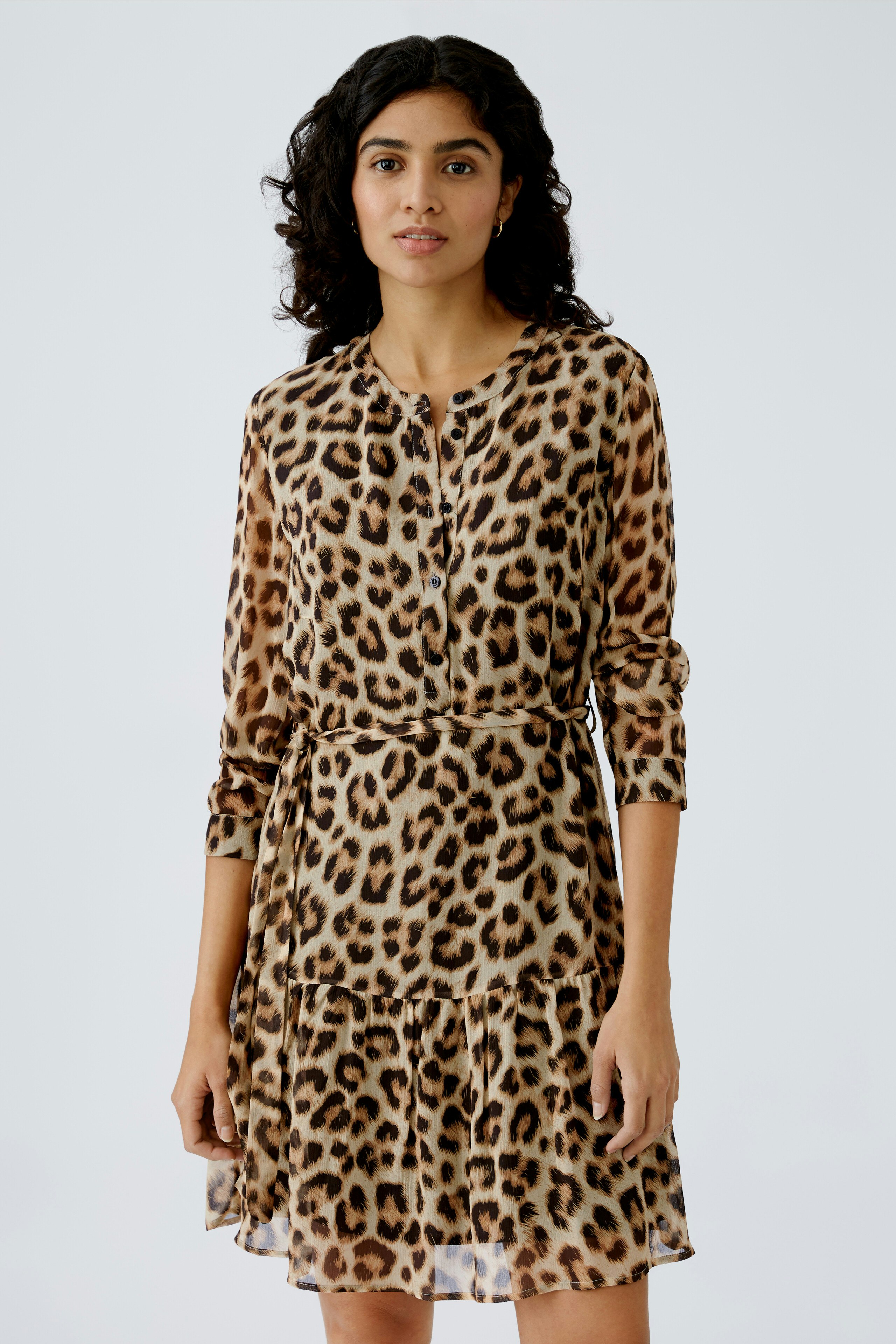 Leopard print dress: A woman in a stylish, lightweight dress with a flattering silhouette.