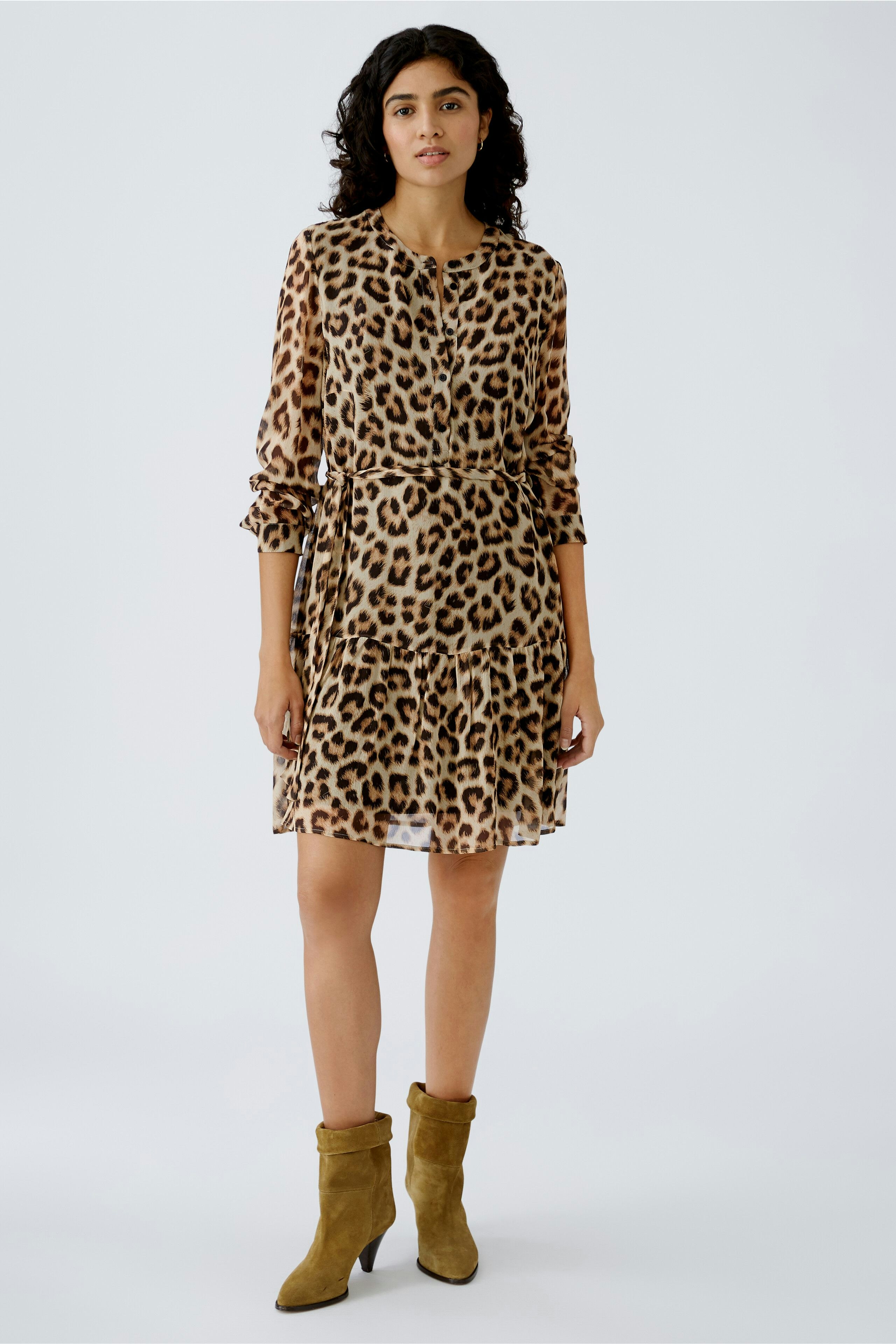 Leopard print dress: A woman in a stylish, flowing dress with a flattering silhouette and ruffled sleeves.