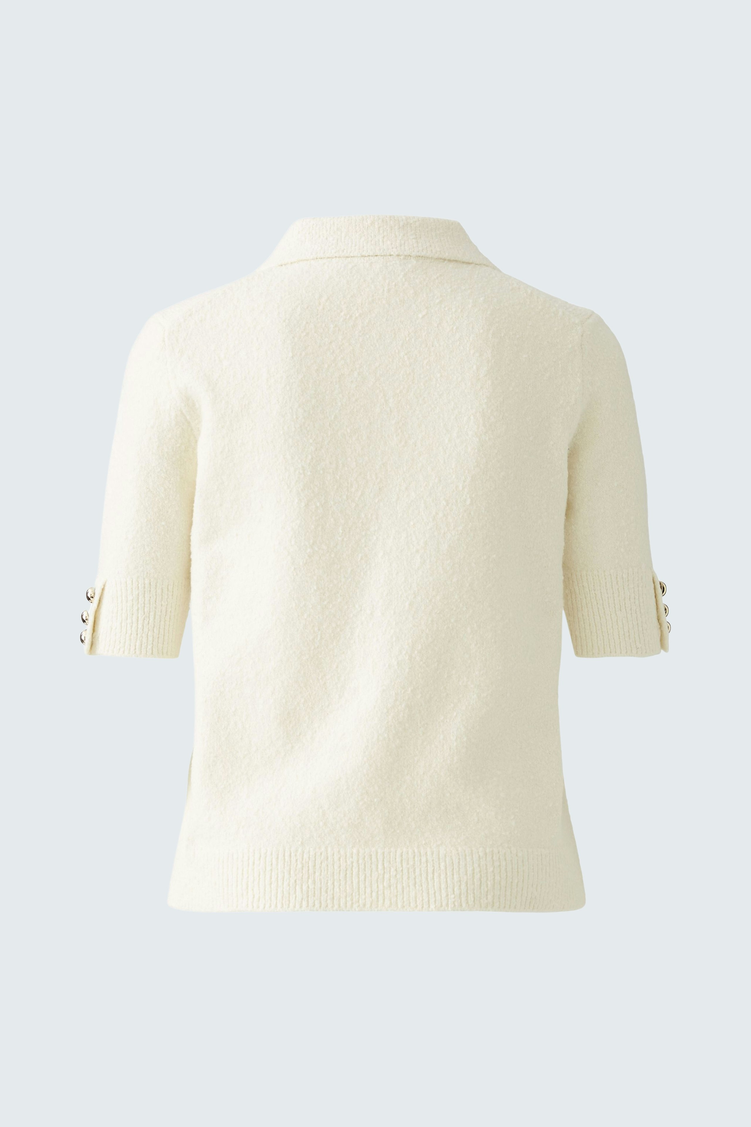 Elegant women's pullover in soft cream with short sleeves and stylish button details.