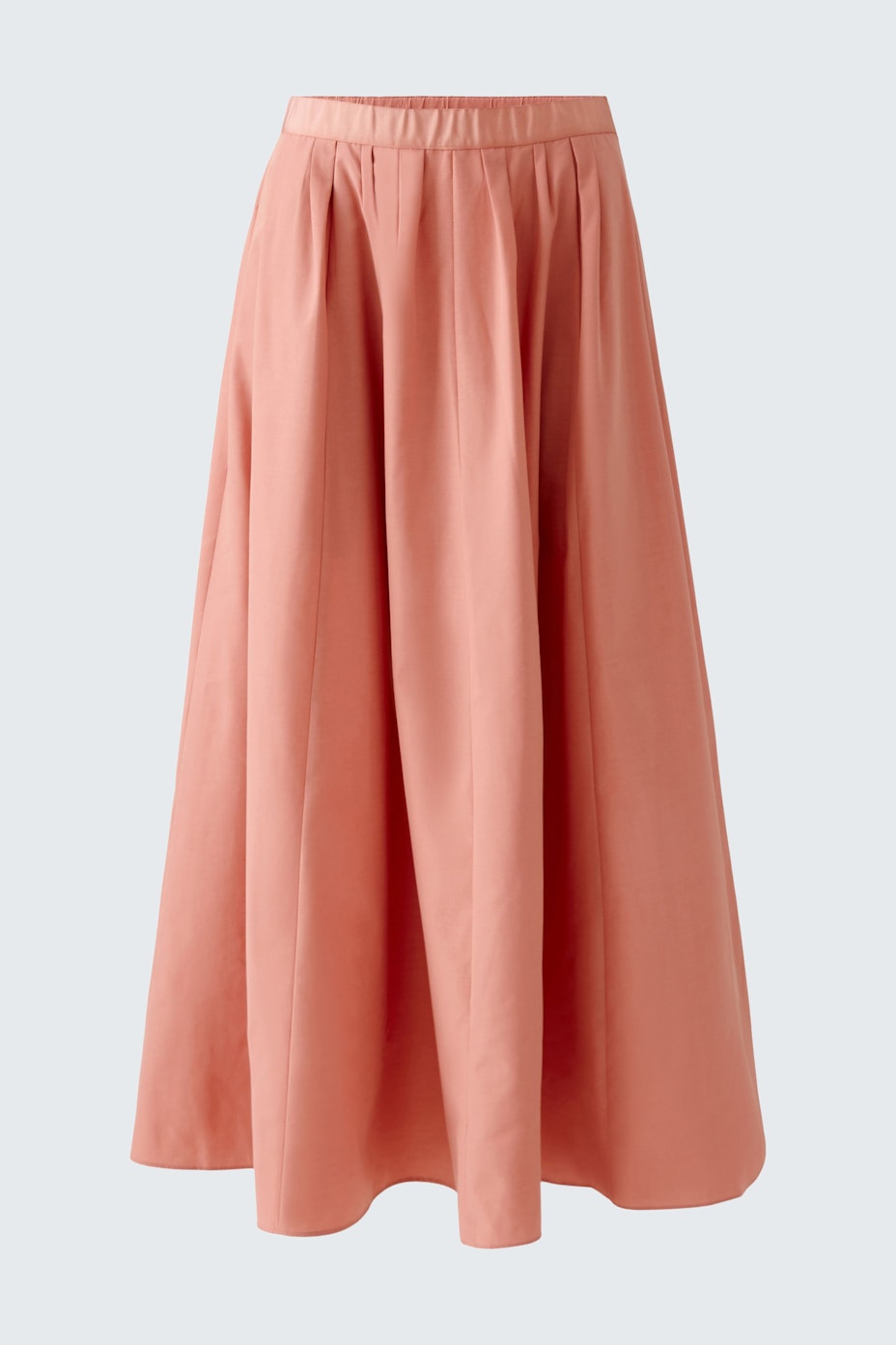 Elegant maxi skirt in soft peach color, perfect for stylish summer outfits.