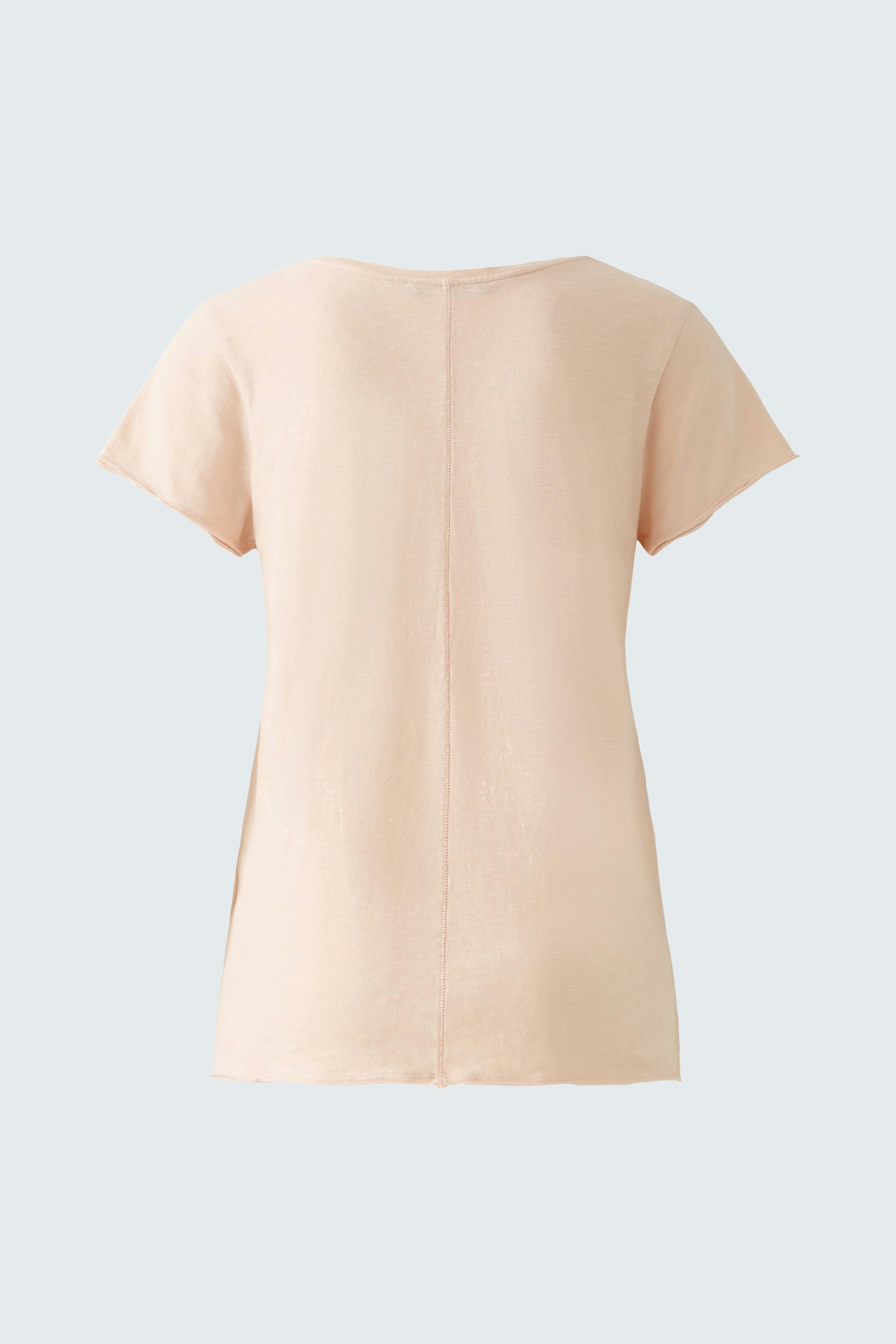 Elegant women's T-shirt in soft peach color, featuring a minimalist design and short sleeves.