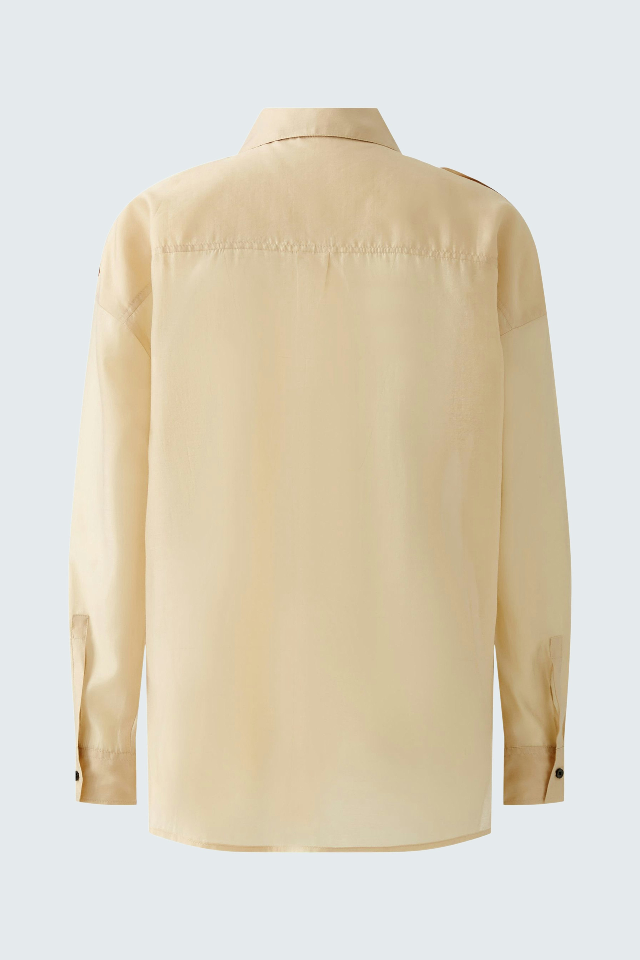 Elegant women's blouse in soft beige, featuring a classic collar and long sleeves.