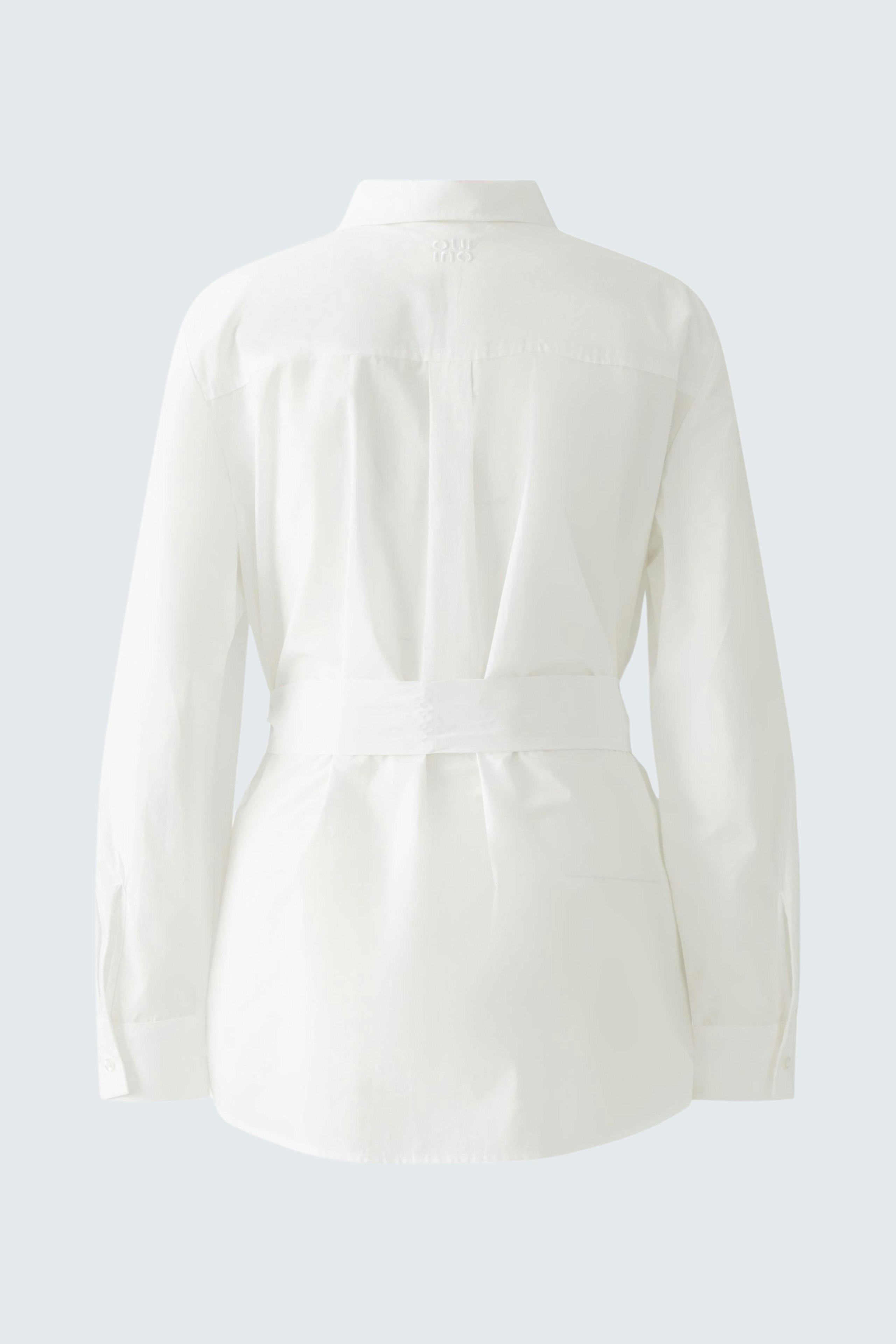 Elegant women's blouse: A stylish white blouse with a belted waist, perfect for any occasion.