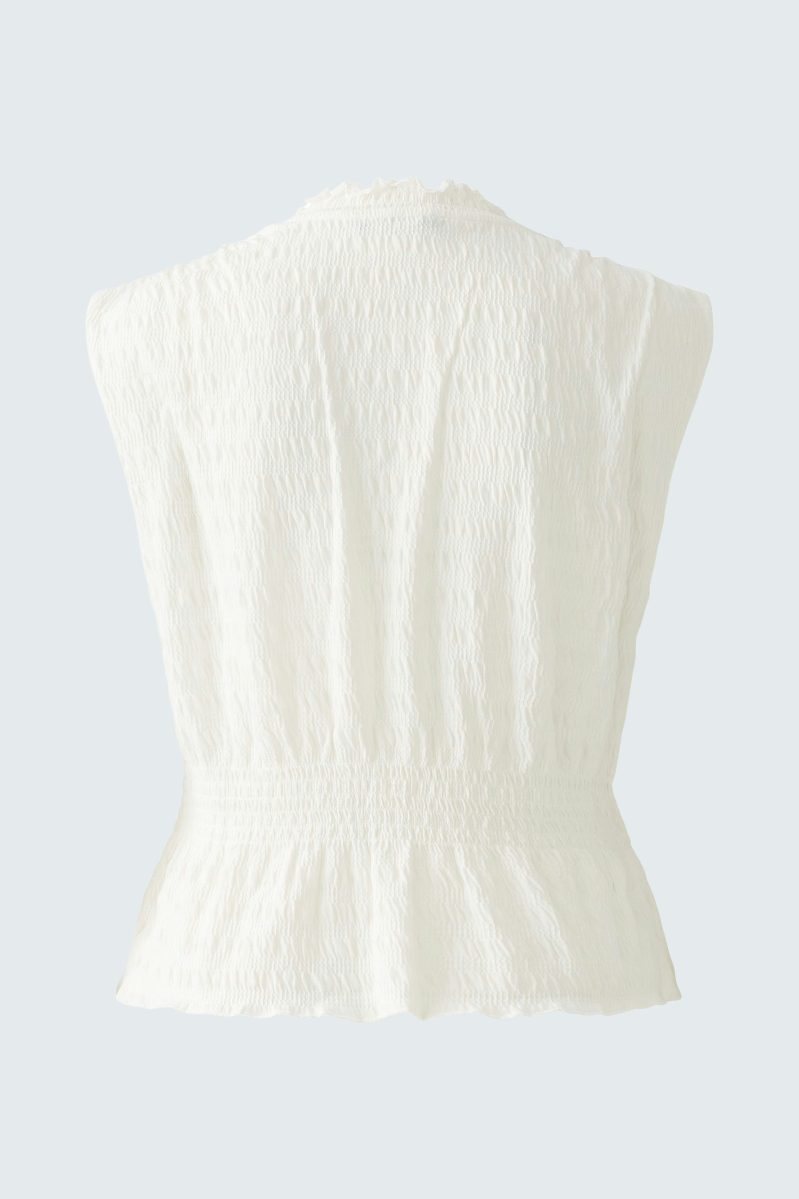 Elegant women's top: A white sleeveless design with a cinched waist, perfect for warm days.