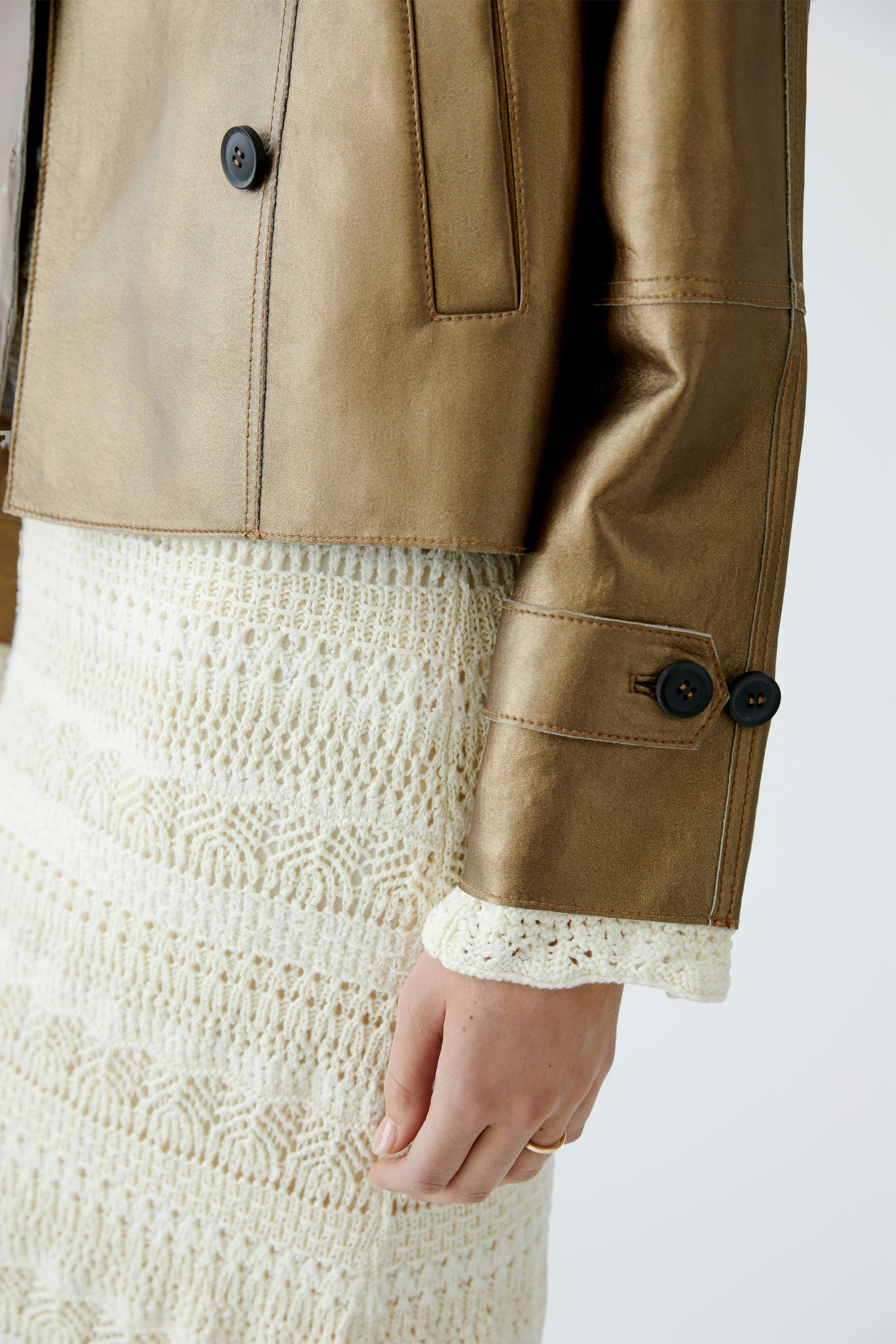 Stylish women's leather jacket: A close-up of a woman wearing a chic brown leather jacket with button details.