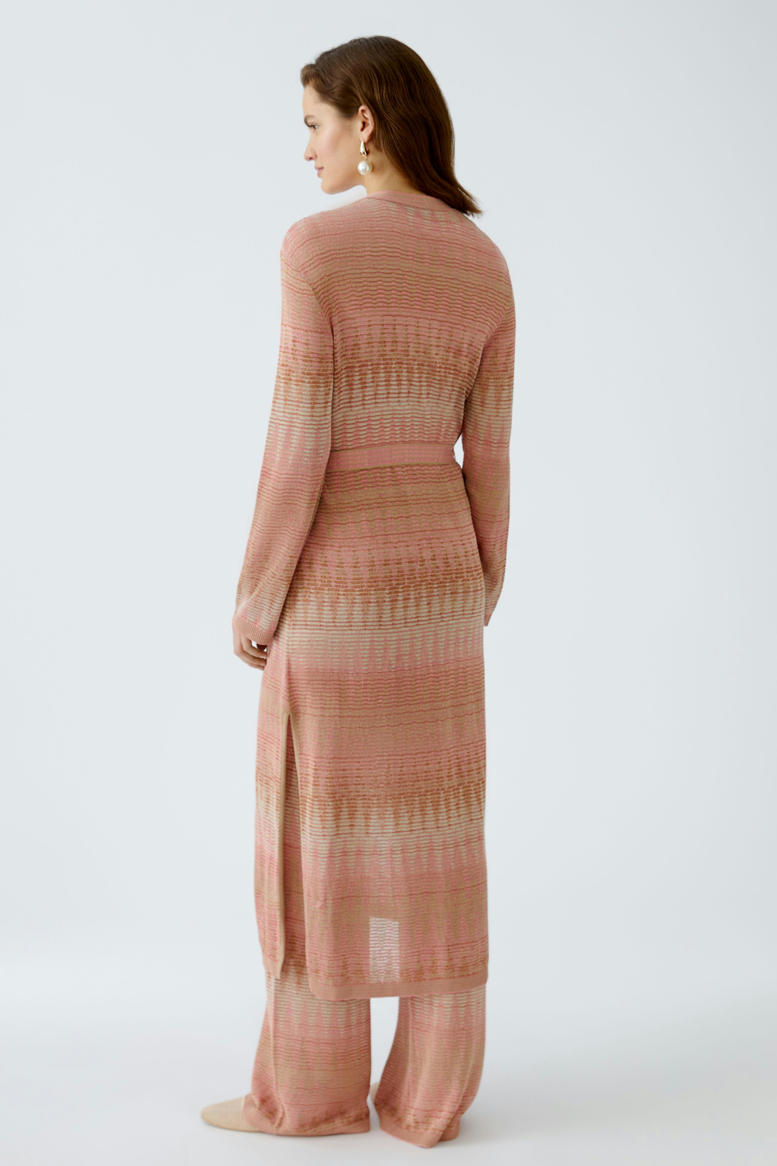 Elegant women's cardigan in soft pink with a stylish design, perfect for layering.