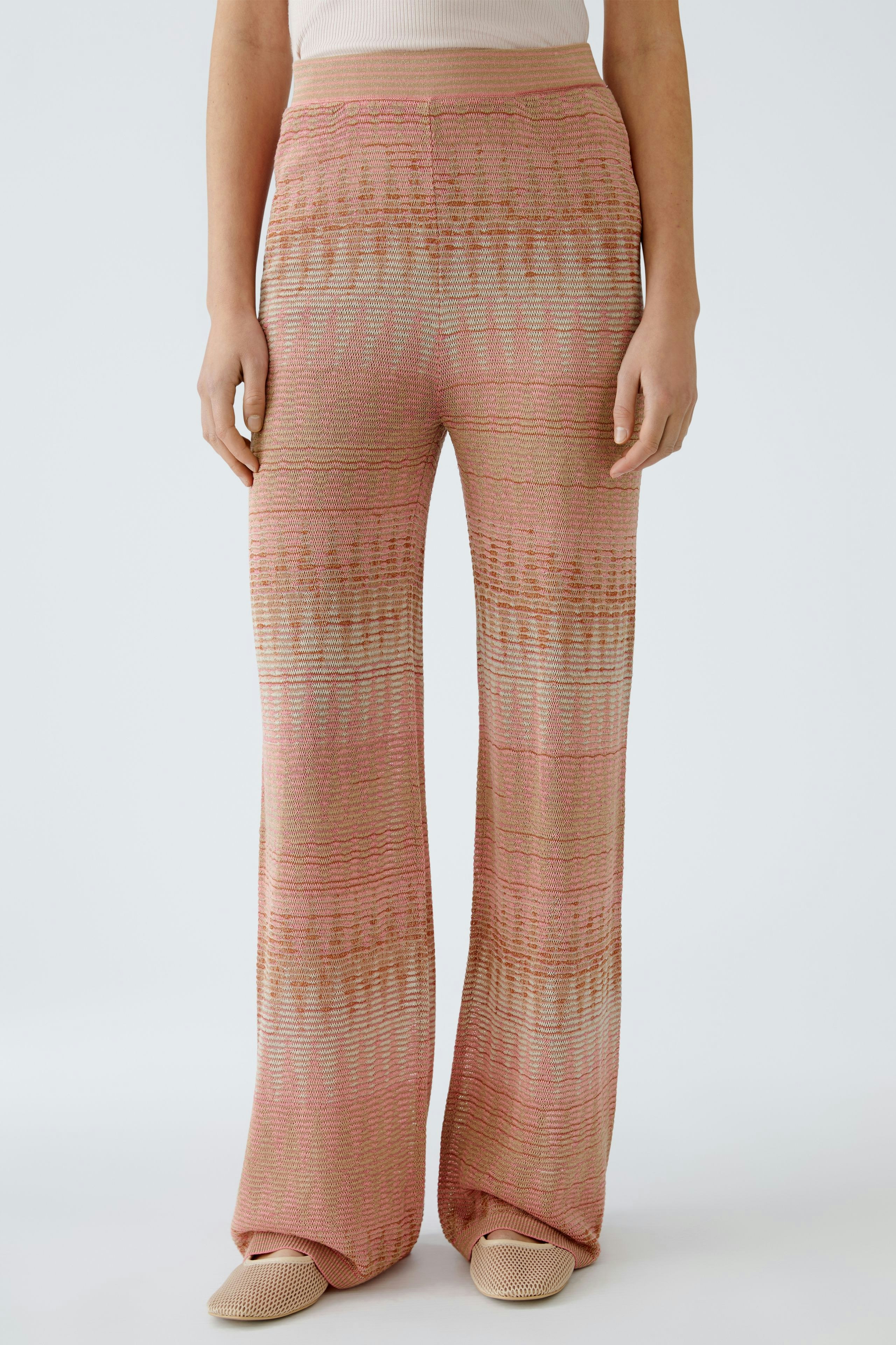 Moderne Strickhose: Frau trägt farbenfrohe, weite Strickhose mit einzigartigem Muster und lässigem Schnitt.