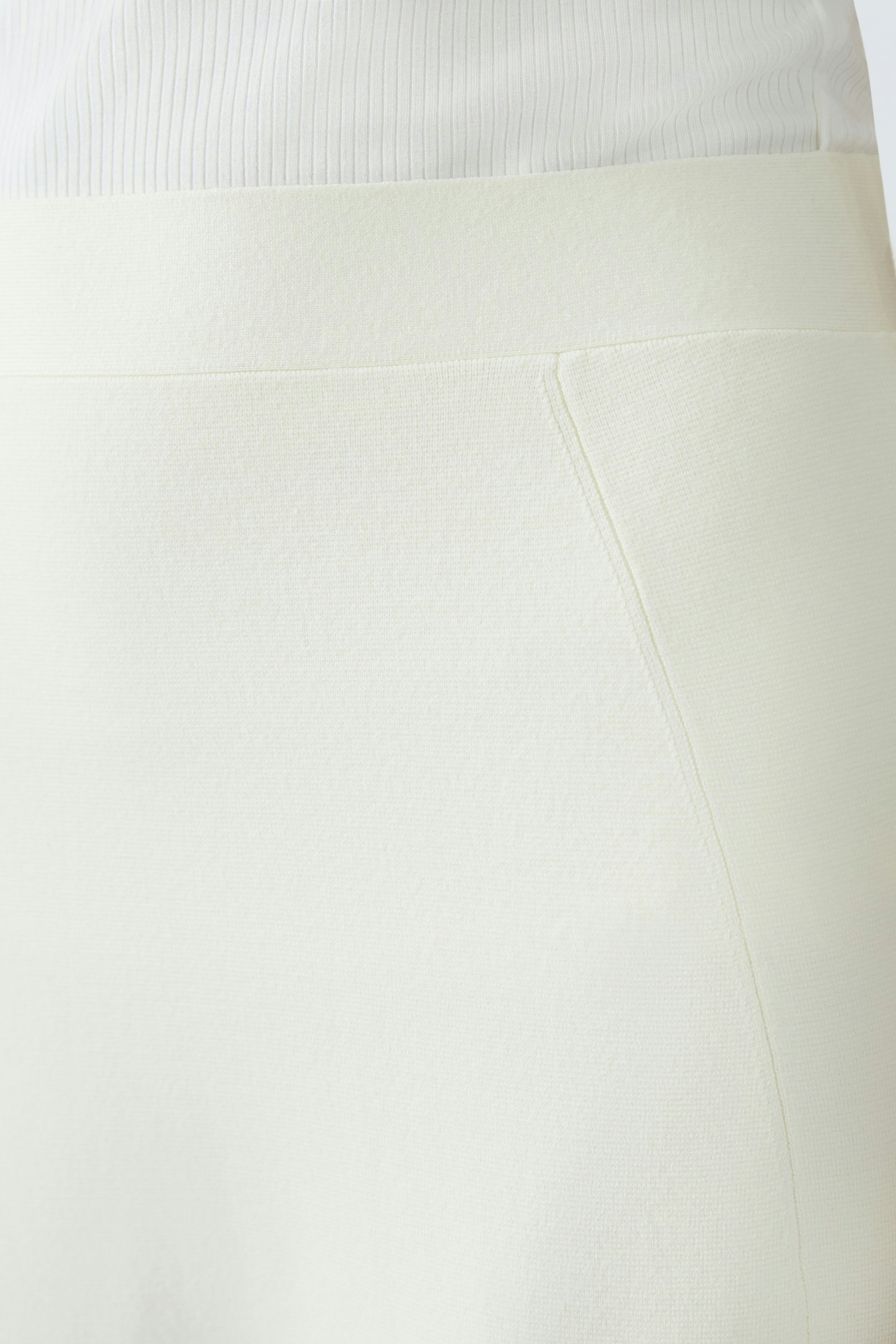 Elegant women's knitted skirt in soft white fabric, perfect for versatile styling.