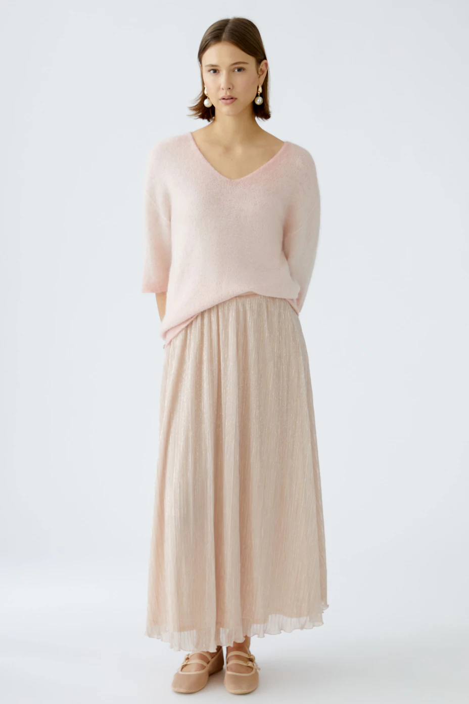 Elegant maxi skirt in soft peach color, featuring a flowing design and comfortable waistband.