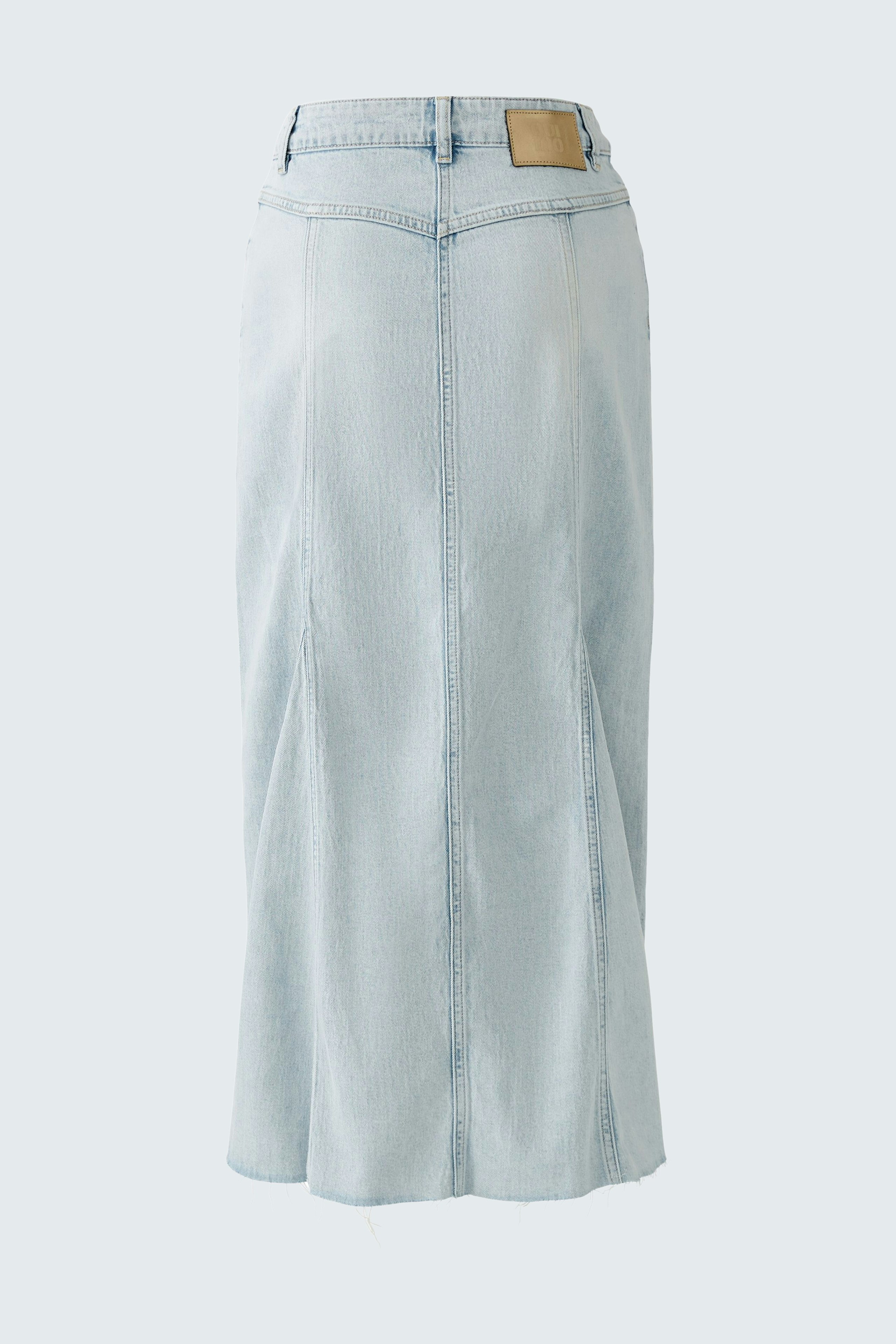 Stylish denim skirt: A light blue, knee-length skirt with a frayed hem, perfect for casual outfits.