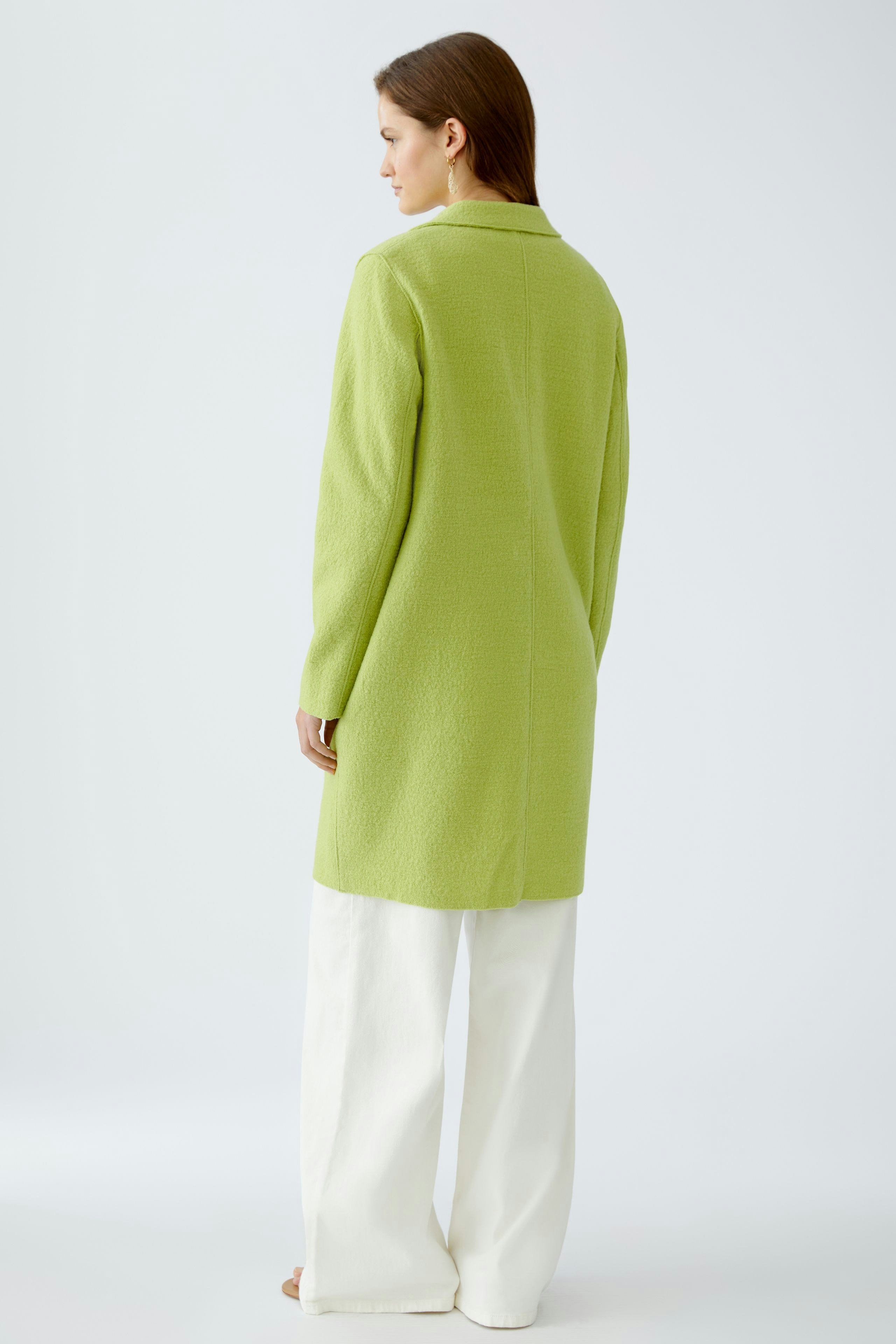 Stylish women's wool coat in vibrant green, featuring a tailored fit and elegant design.