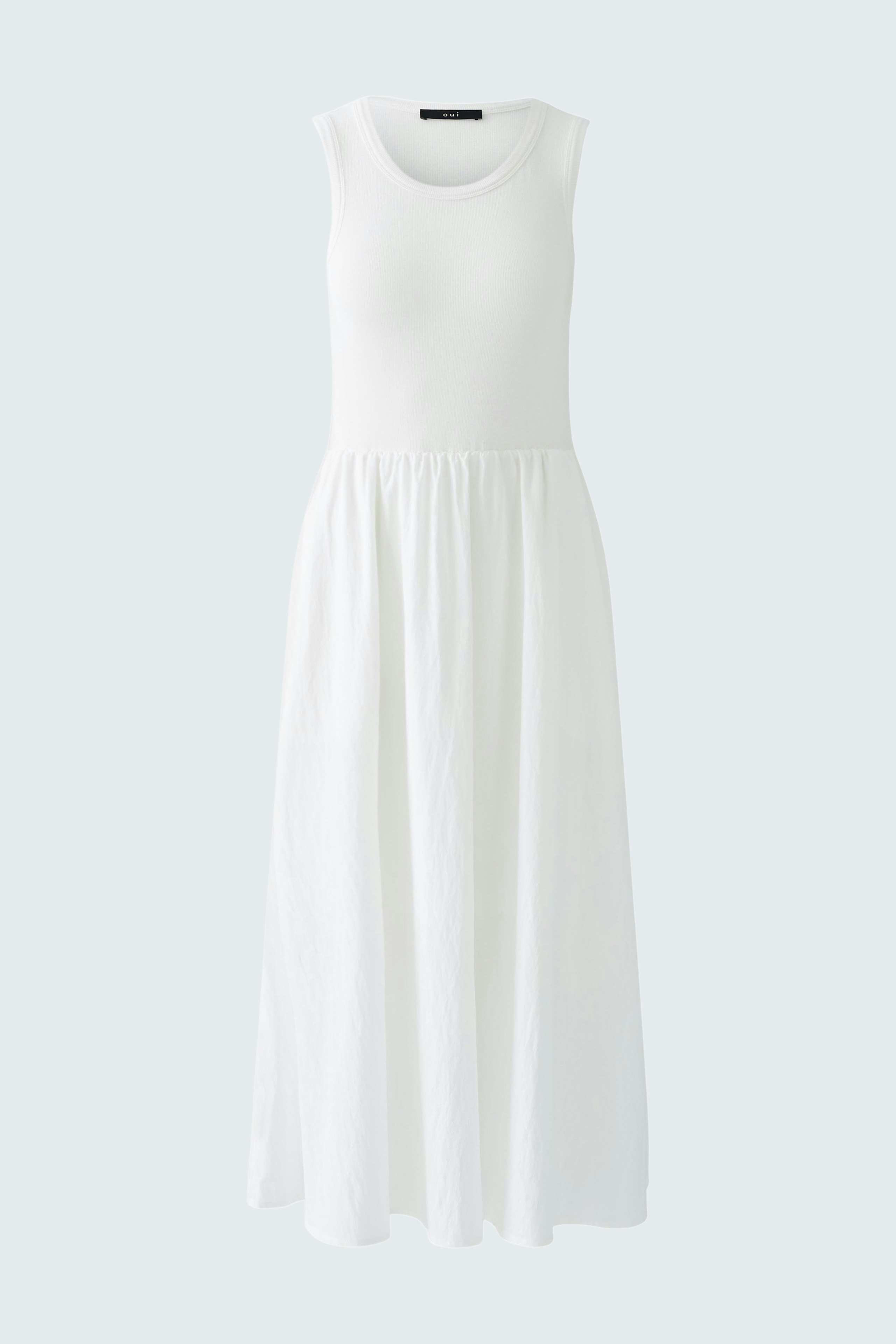 Elegant white dress with a flowing skirt, perfect for summer occasions.