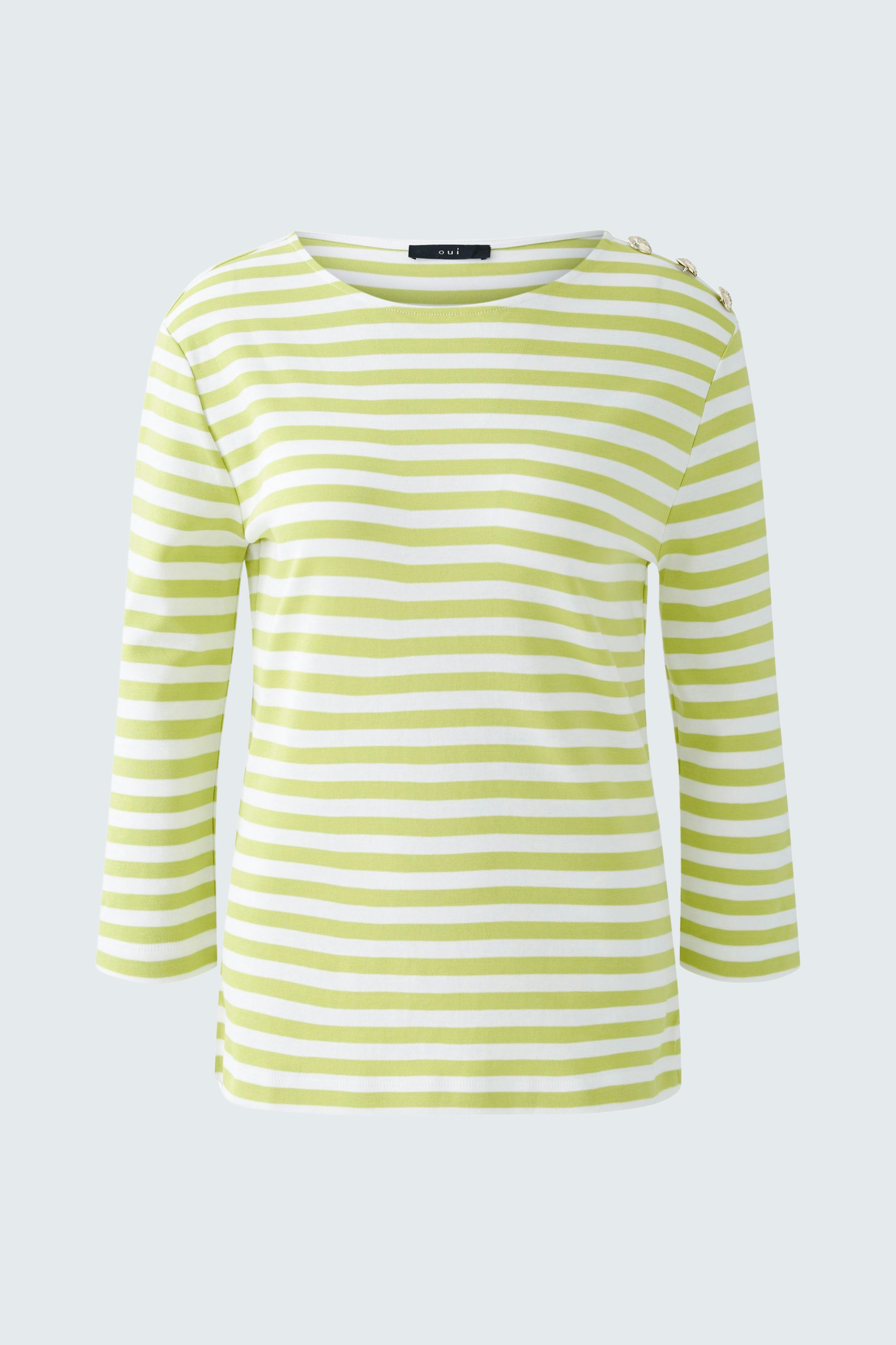 Stylish long-sleeve shirt: A woman in a green and white striped pullover, perfect for casual wear.