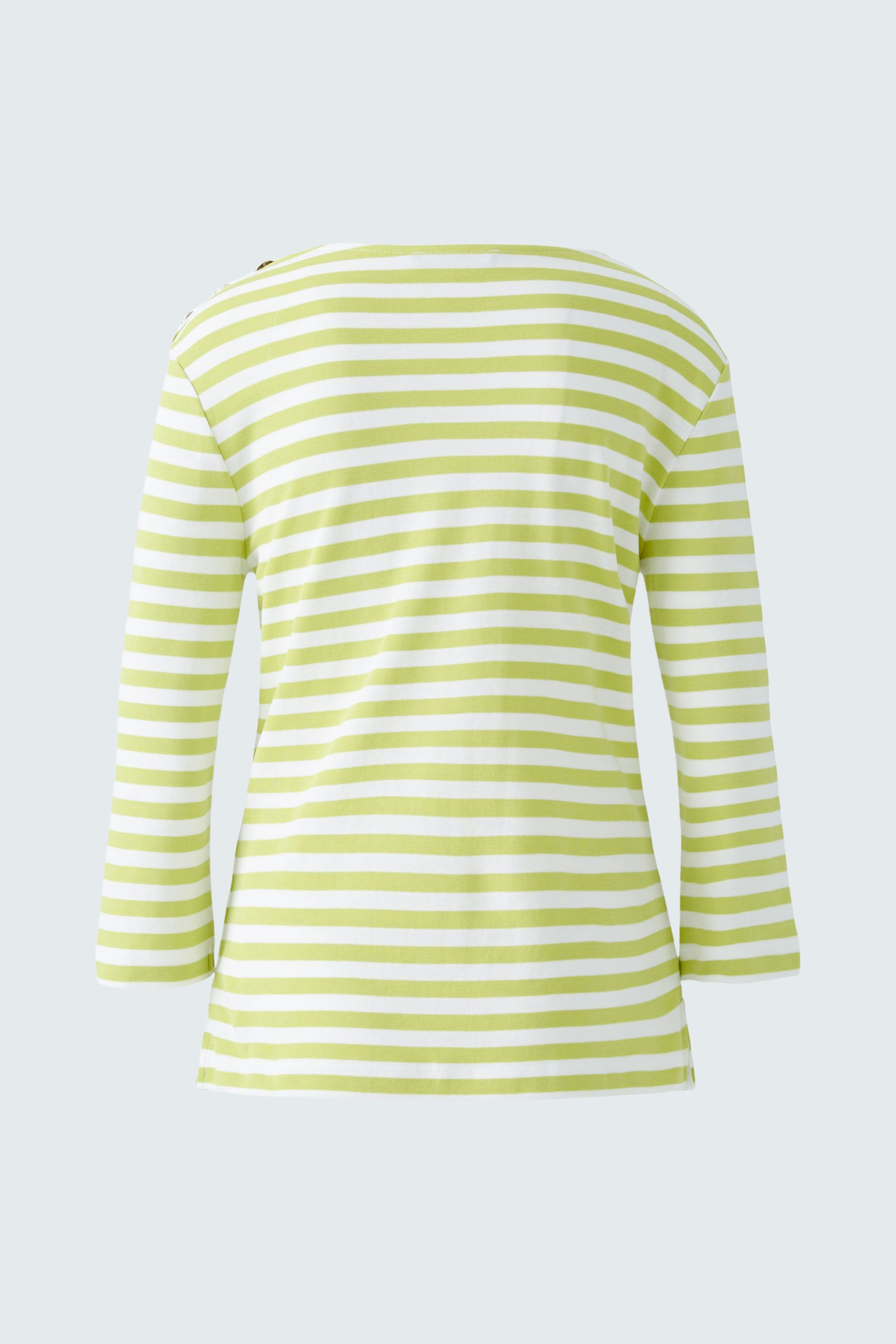 Stylish long-sleeve shirt: A woman in a green and white striped pullover, showcasing a casual look.