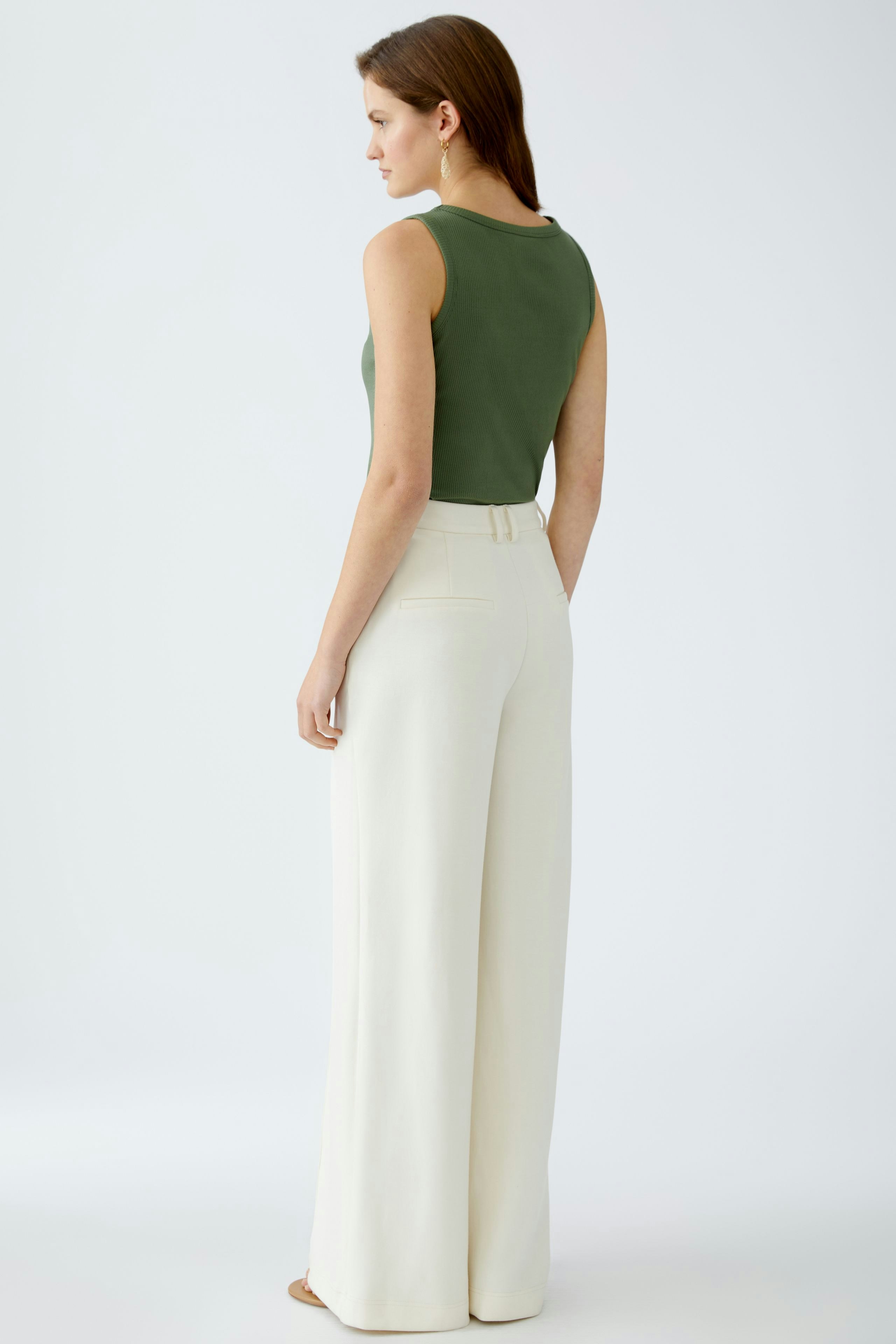 Elegant women's trousers: A woman in high-waisted, wide-leg trousers, showcasing a chic and modern style.