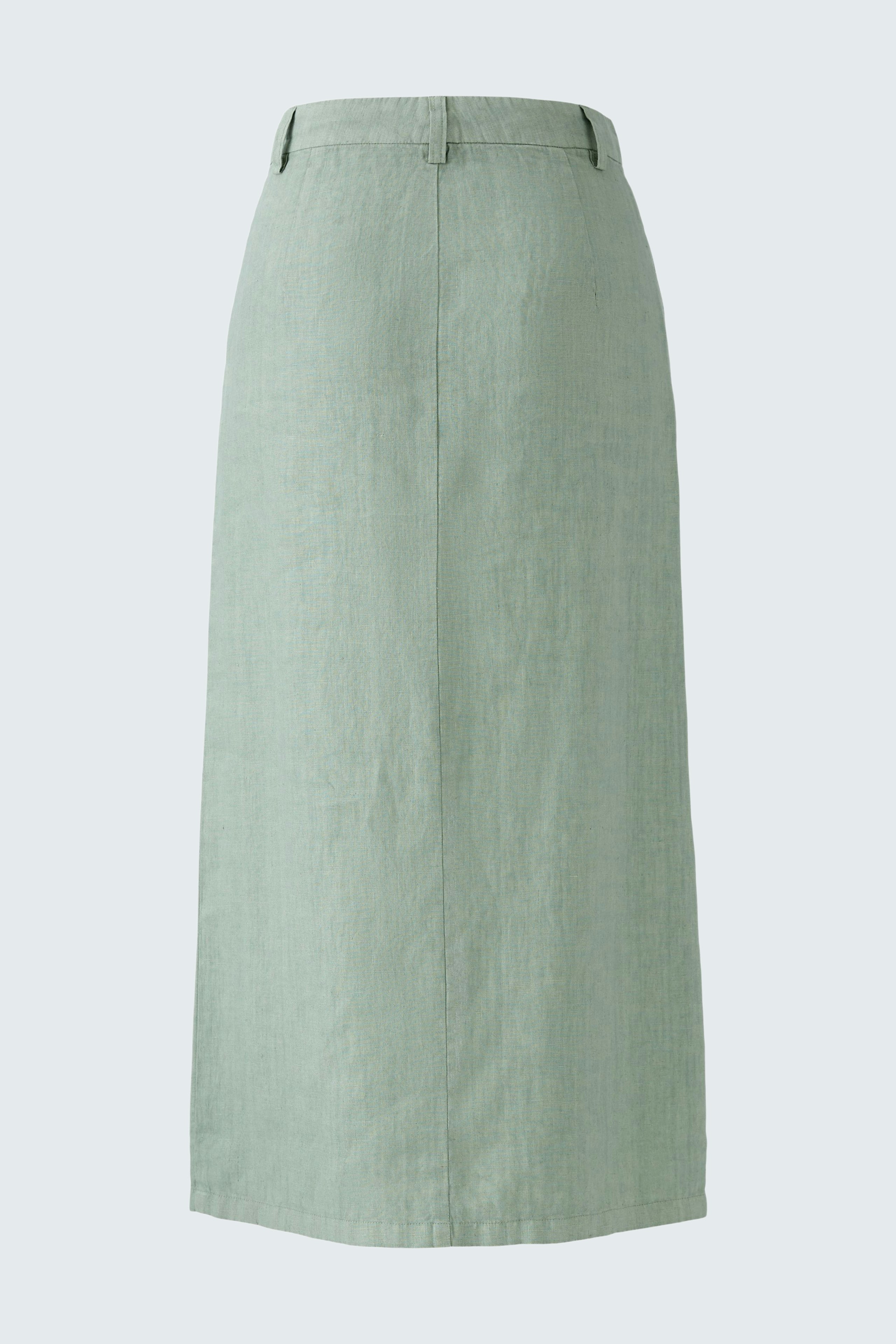 Elegant midi skirt: A woman in a light green midi skirt, perfect for versatile styling.