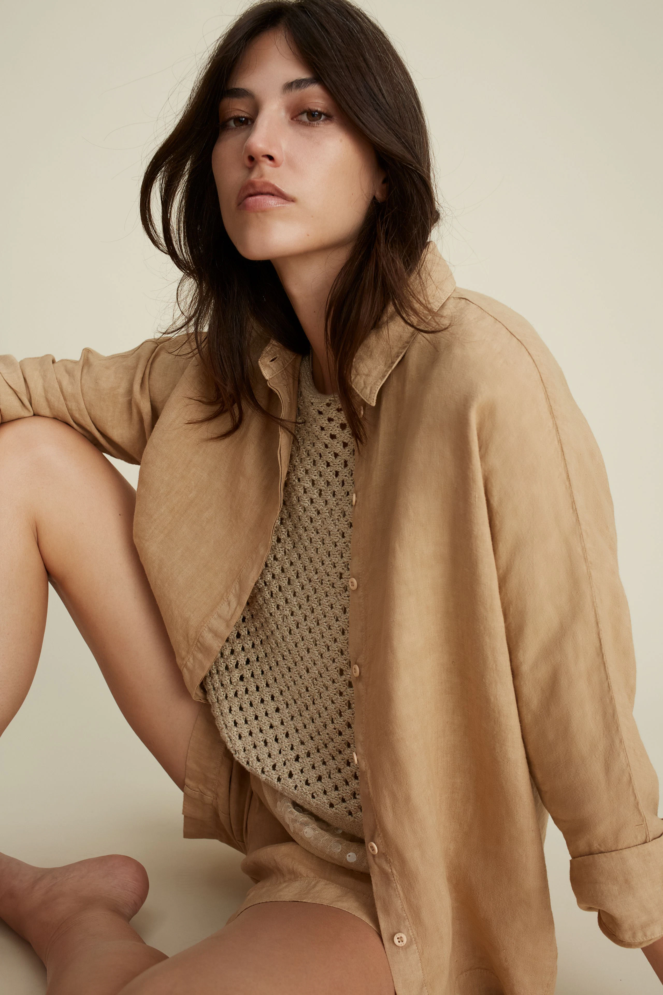 Stylish women's blouse: A woman in a light beige blouse, exuding effortless elegance.