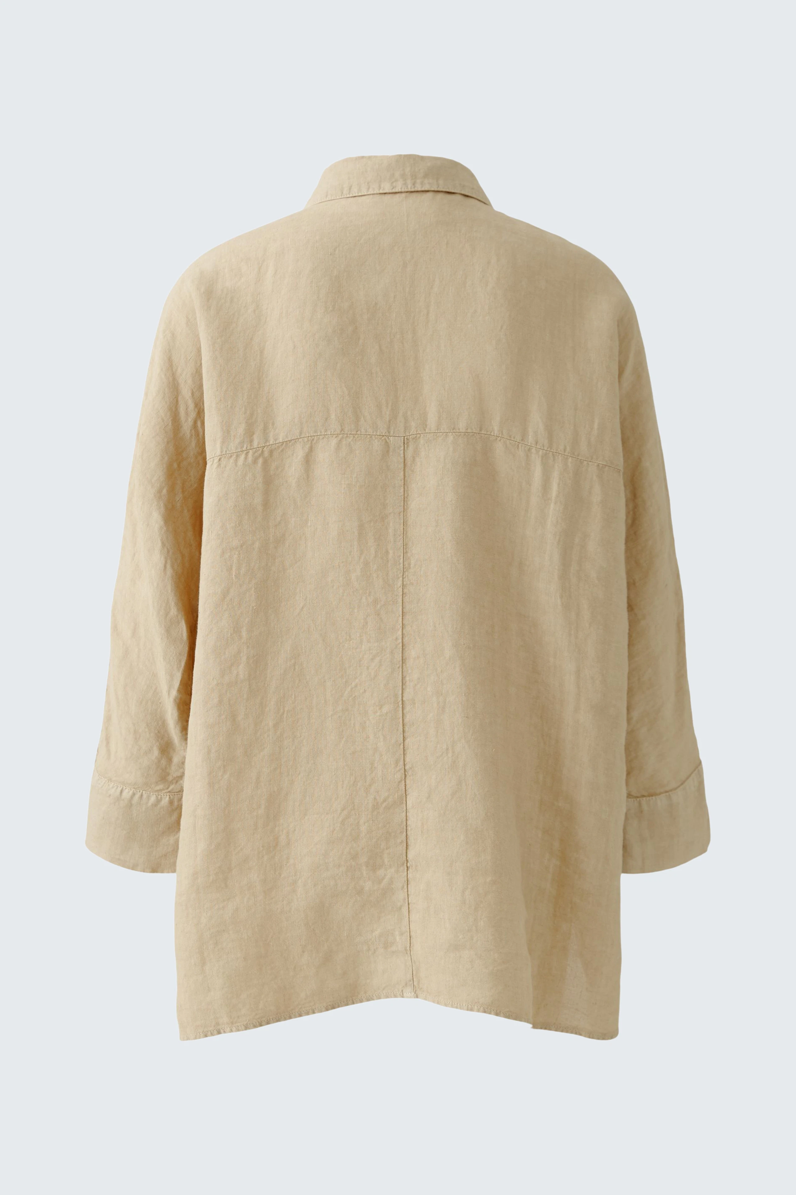Stylish women's blouse: Back view of a light beige blouse with a relaxed fit and rolled sleeves.