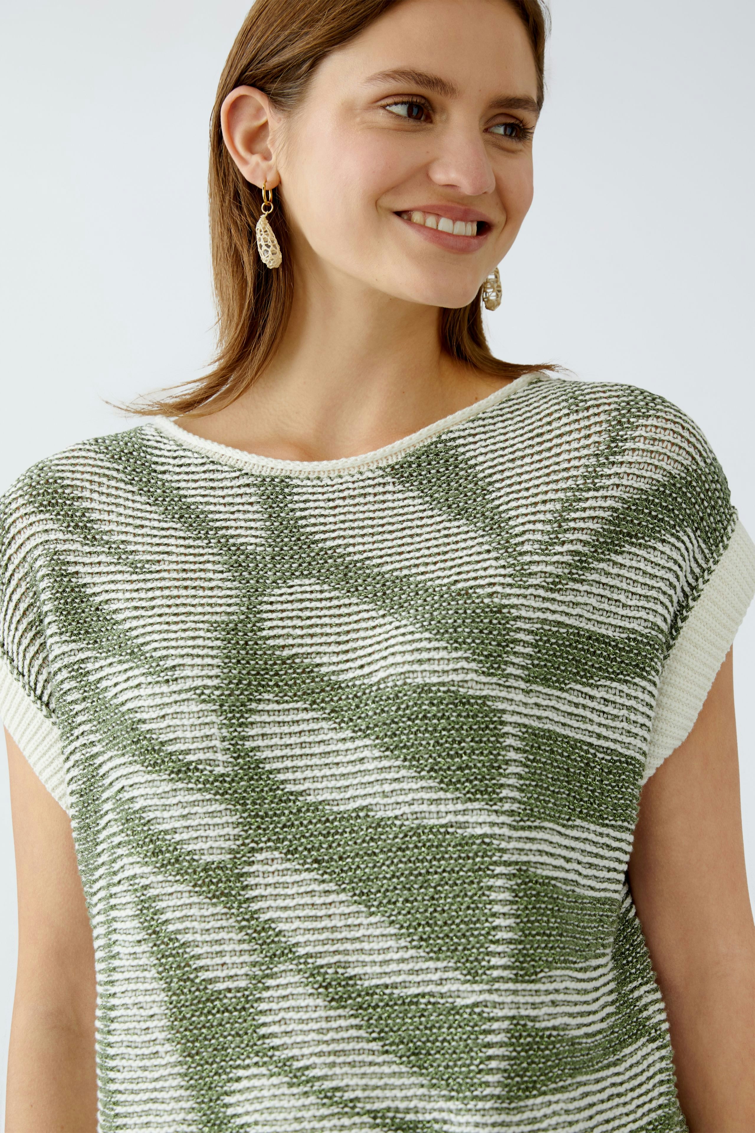 Stylish women's pullover: A woman smiles in a green and white patterned pullover, perfect for casual wear.