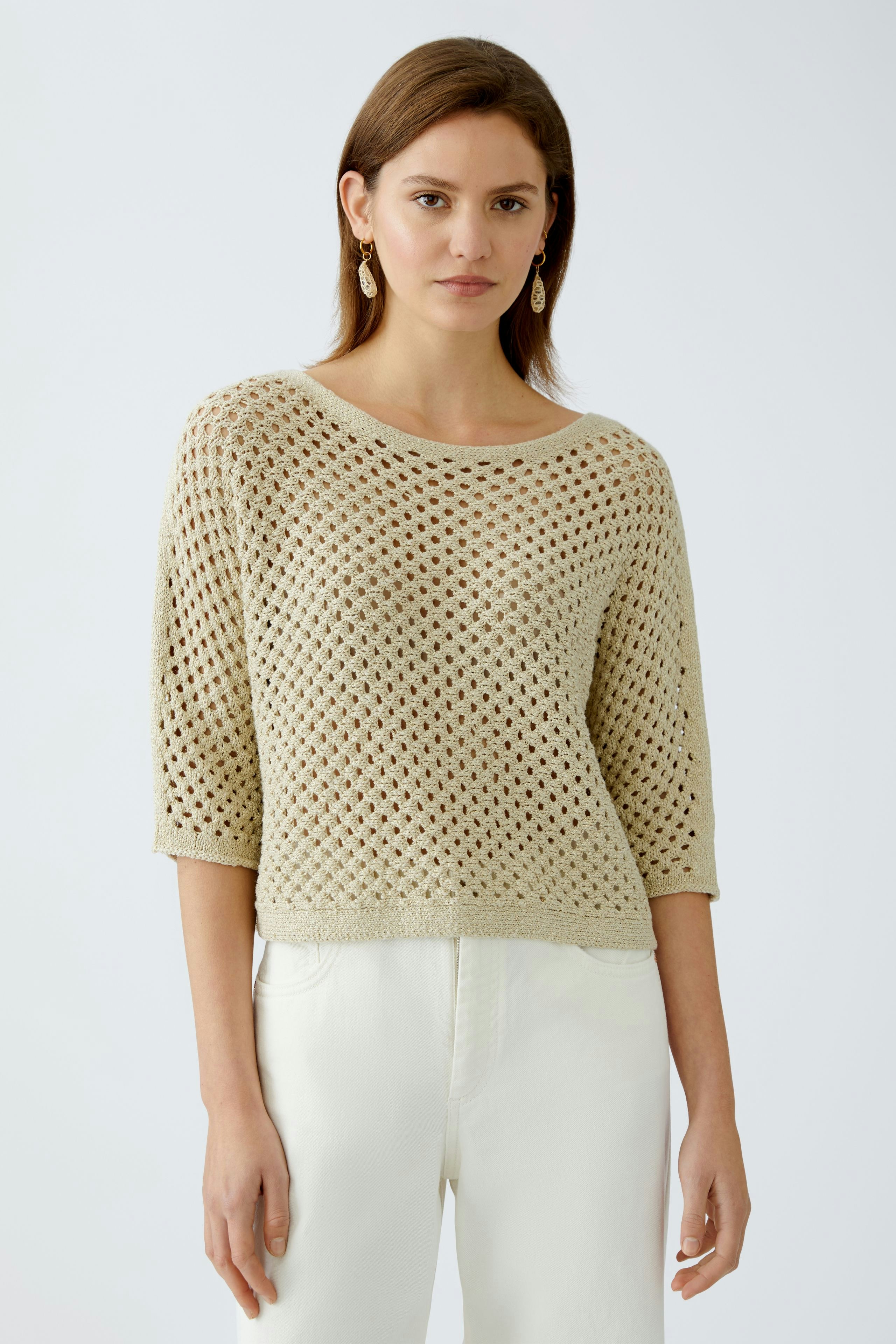 Stylish women's pullover: A woman in a light, airy knit pullover with a relaxed fit.