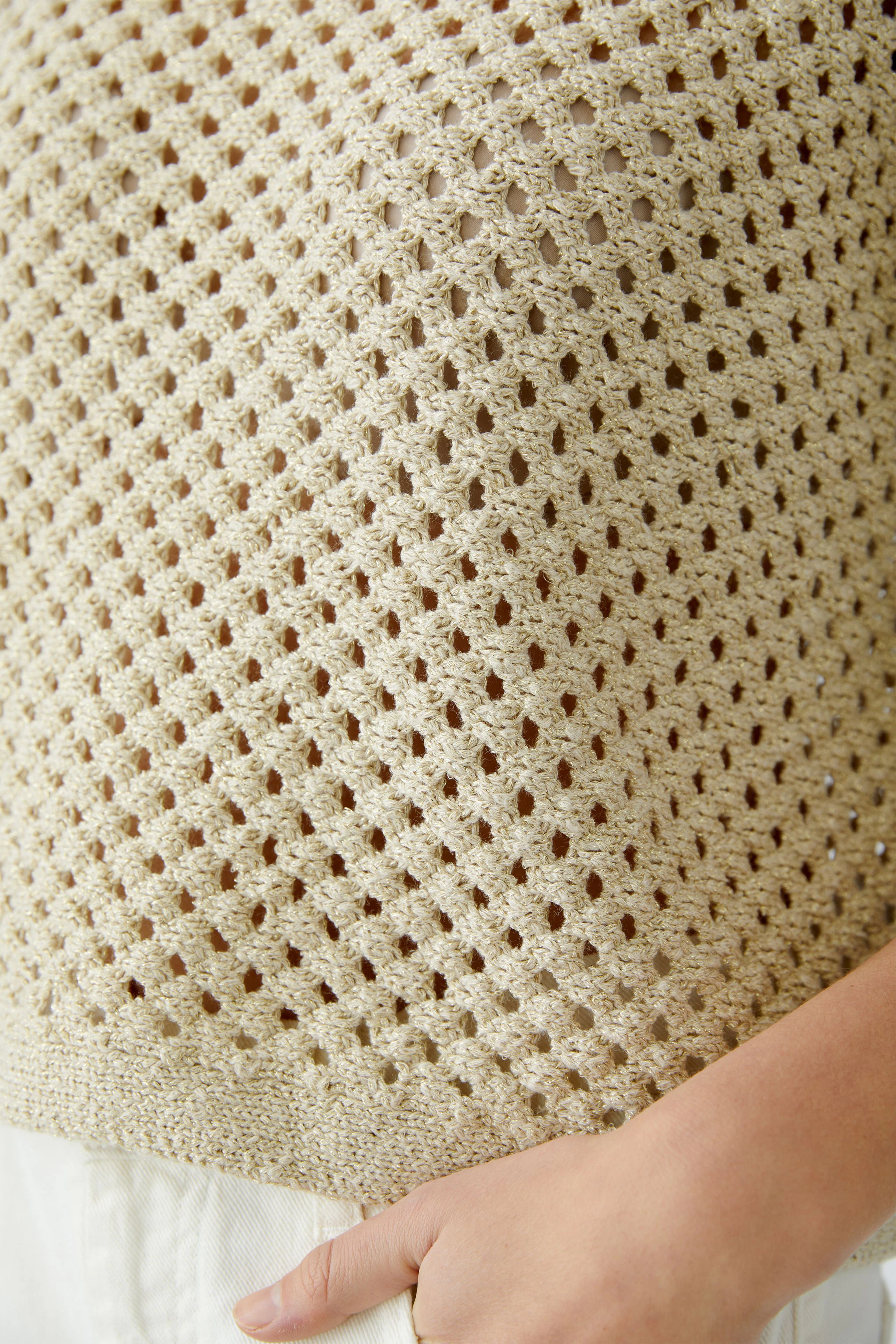 Lightweight women's pullover with a delicate open knit design, perfect for layering.