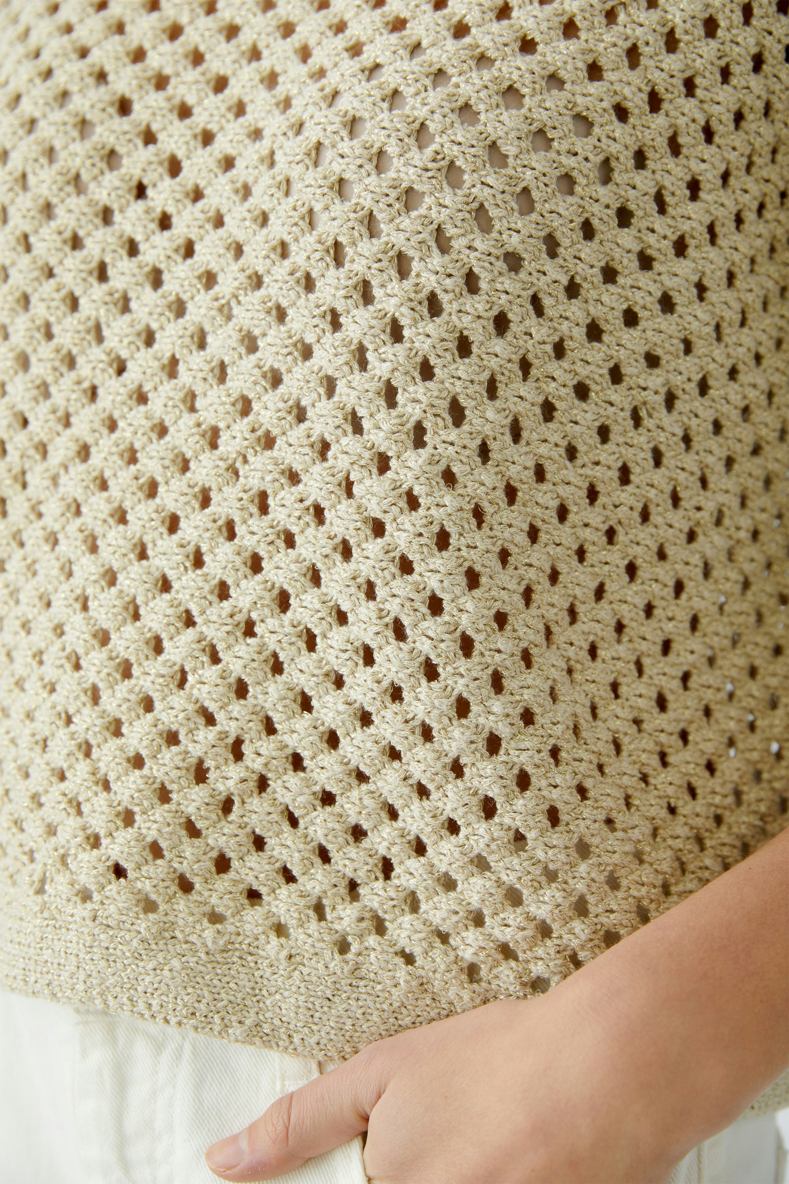 Lightweight women's pullover with a delicate open knit design, perfect for layering.