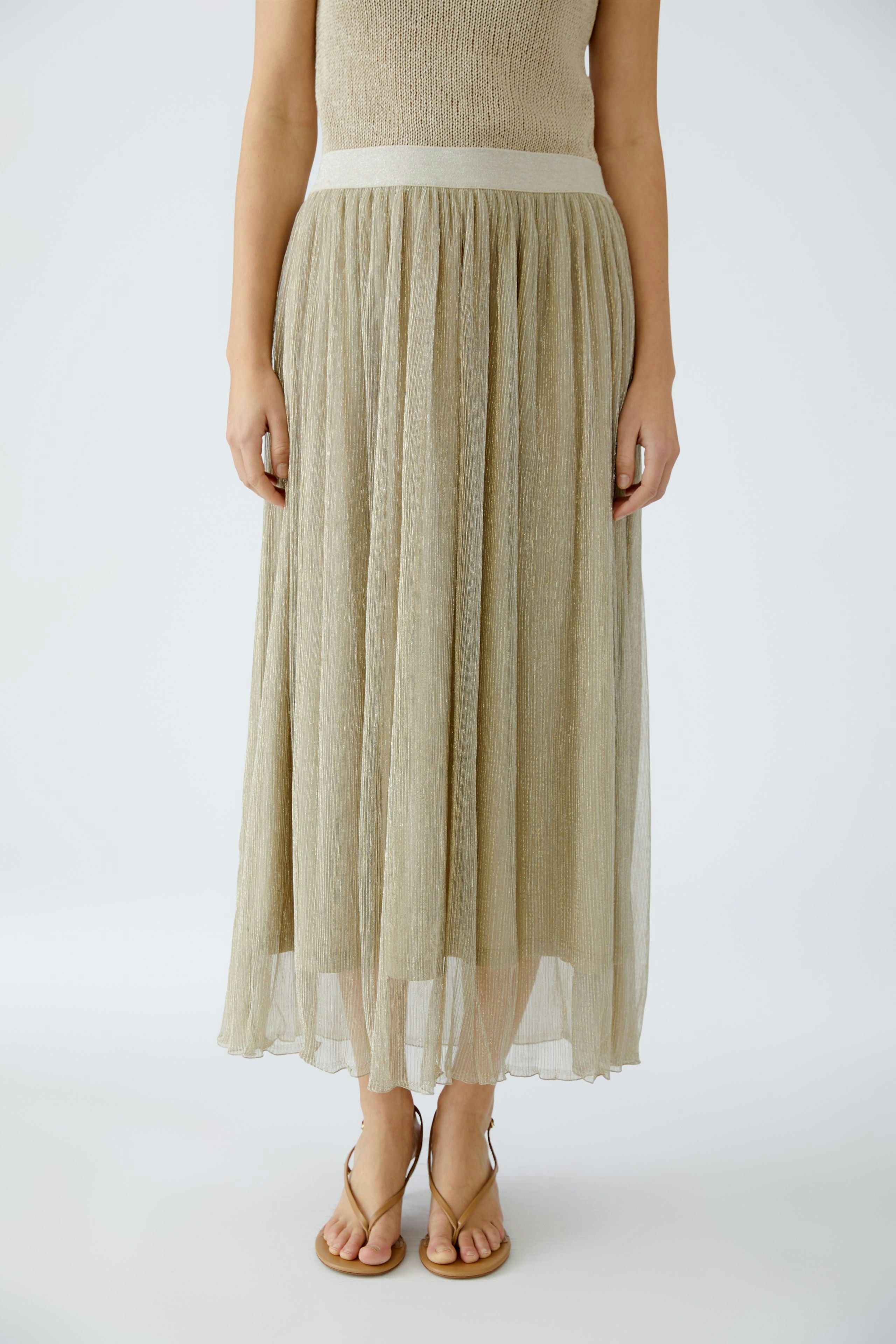 Elegant maxi skirt: A woman in a shimmering, floor-length skirt, perfect for any occasion.