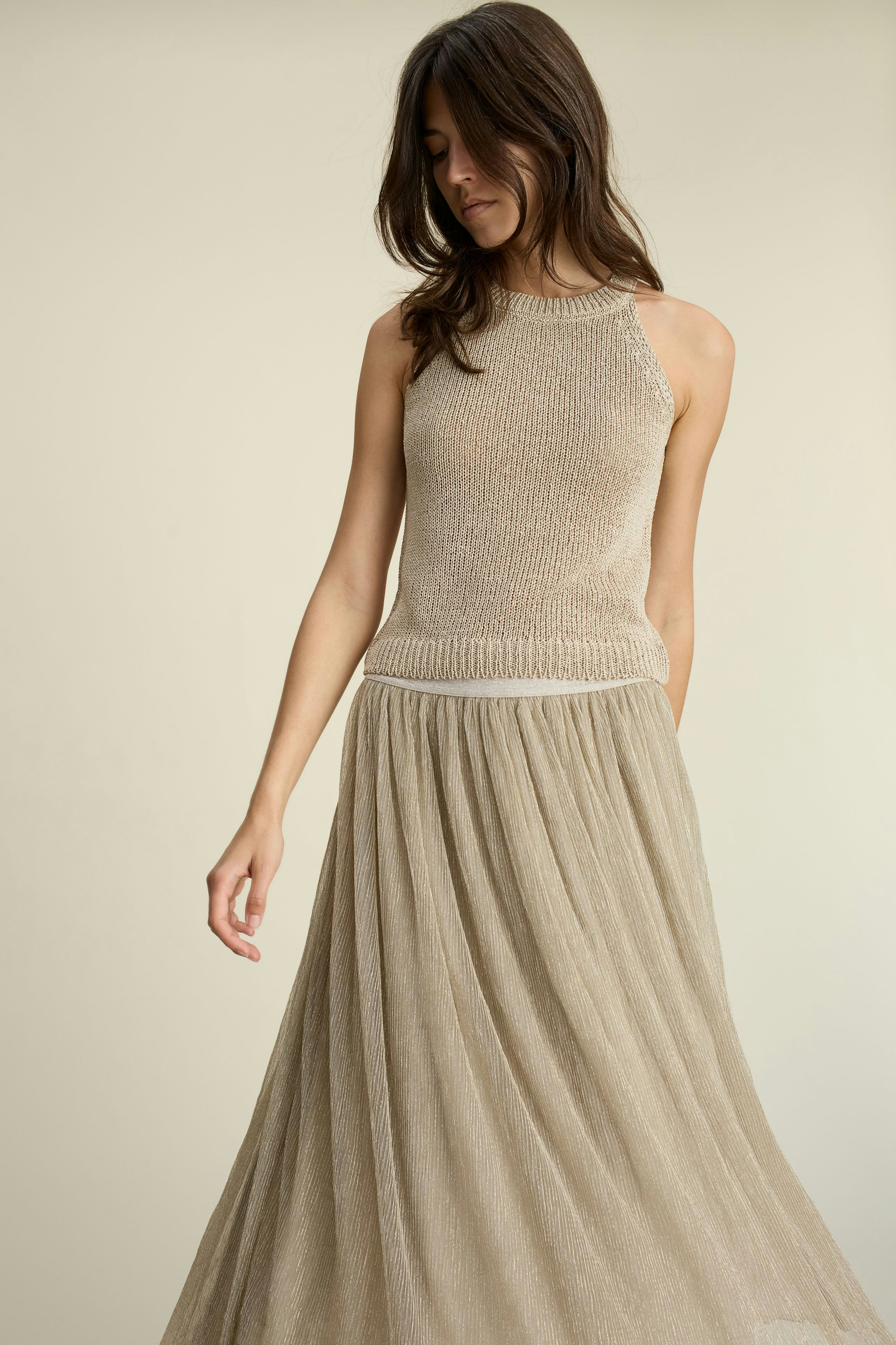 Elegant maxi skirt: A woman in a flowing, light-colored maxi skirt, exuding grace and style.