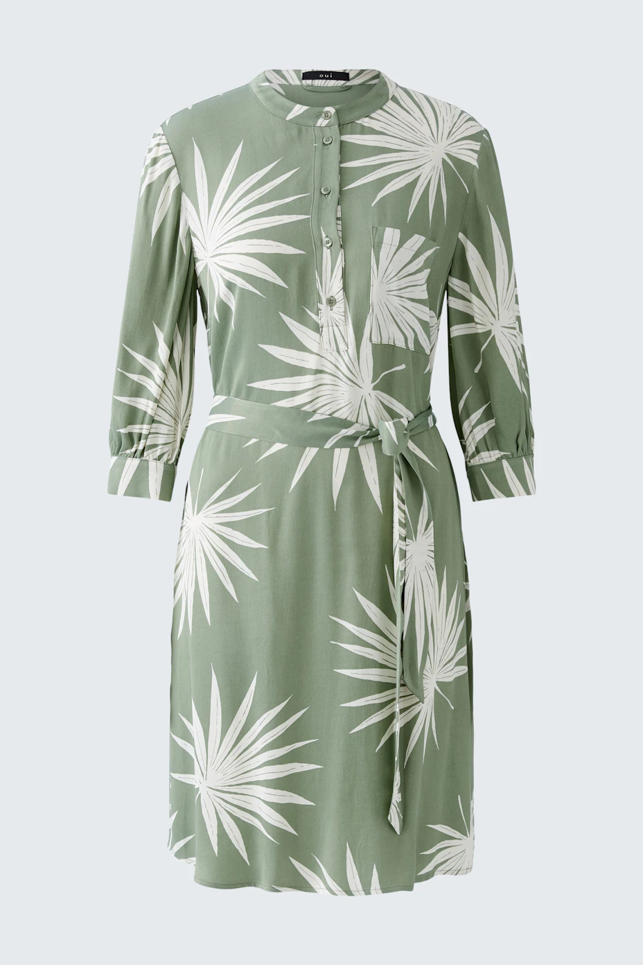 Casual women's dress: A green dress with a leaf print and buttons, featuring a tie waist for a relaxed fit.