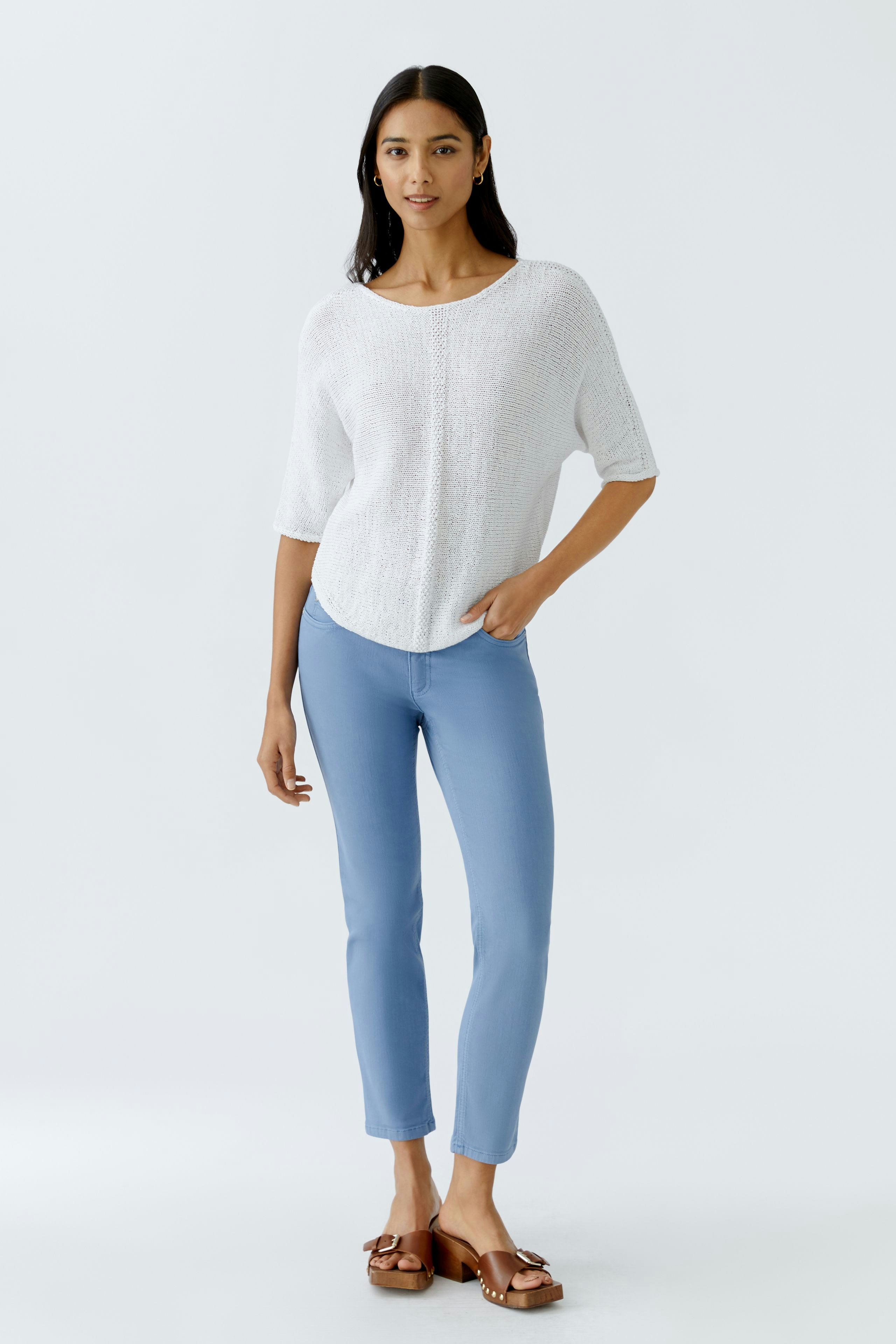 Stylish jeggings: Woman in light blue jeggings paired with a casual white top, exuding effortless elegance.