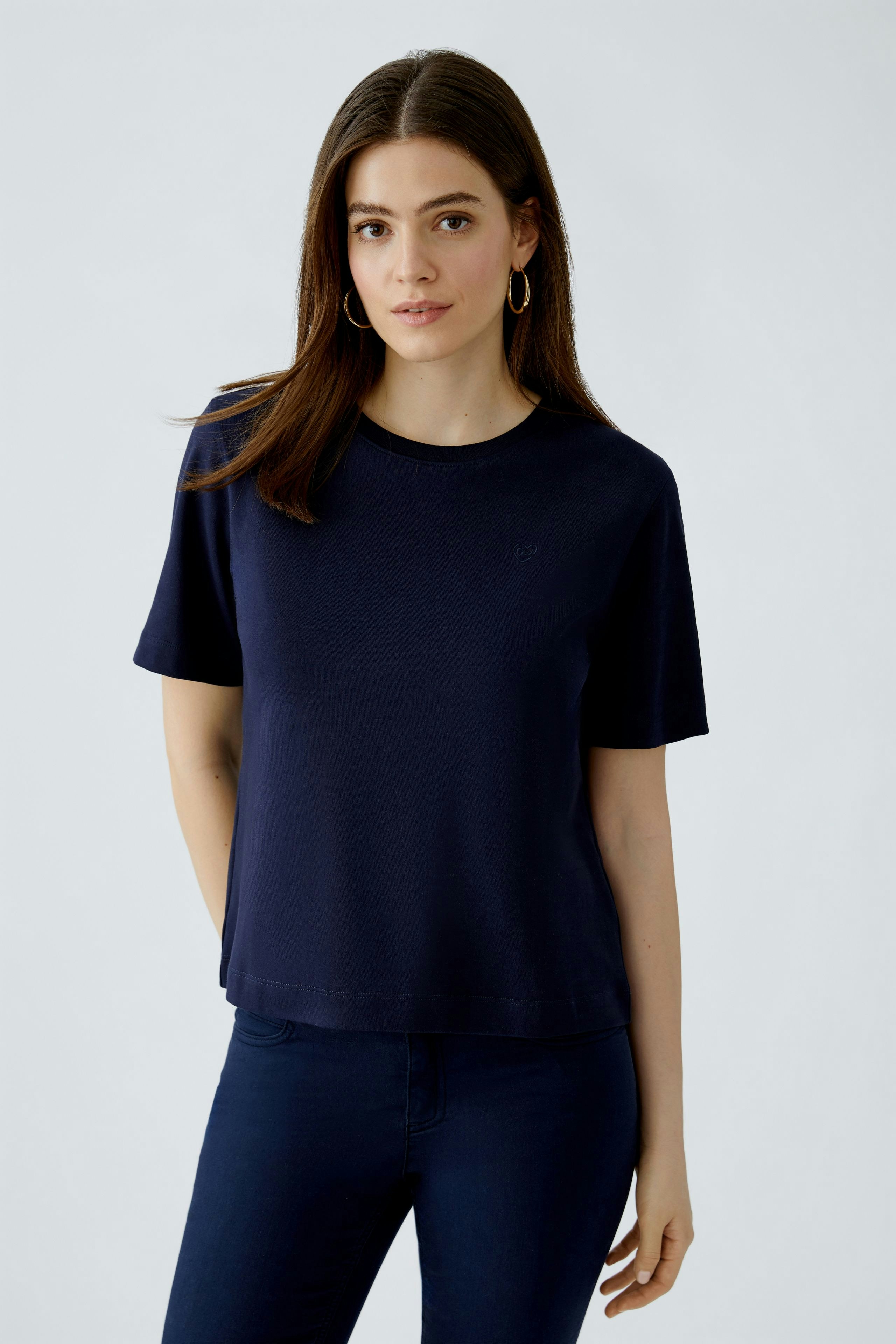 Damen-T-Shirt: Frau in navyblauem T-Shirt mit lässigem Schnitt und Rundhalsausschnitt.