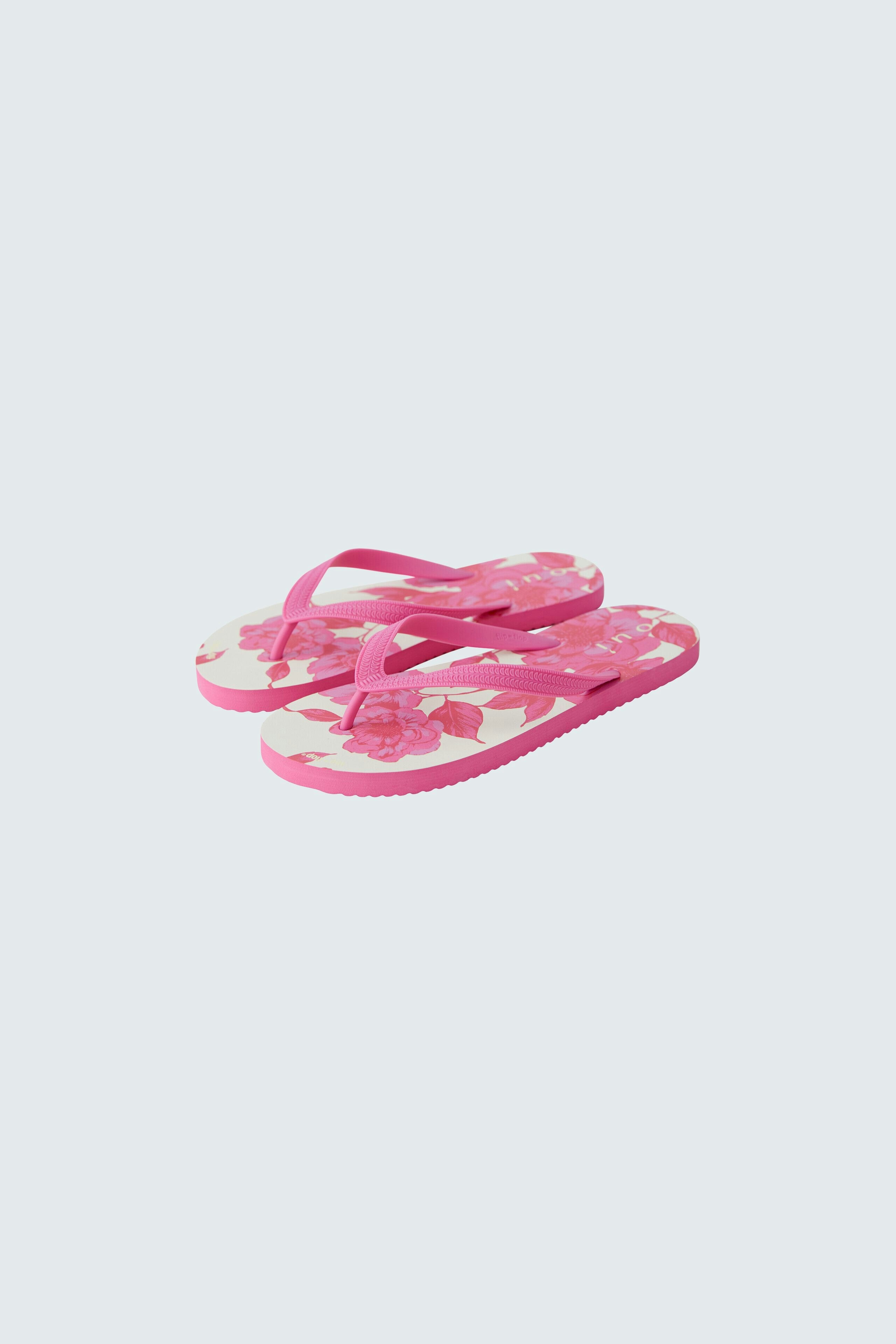 Bequeme Flip Flops in Pink mit floralem Muster, ideal für den Sommer und entspannte Tage.