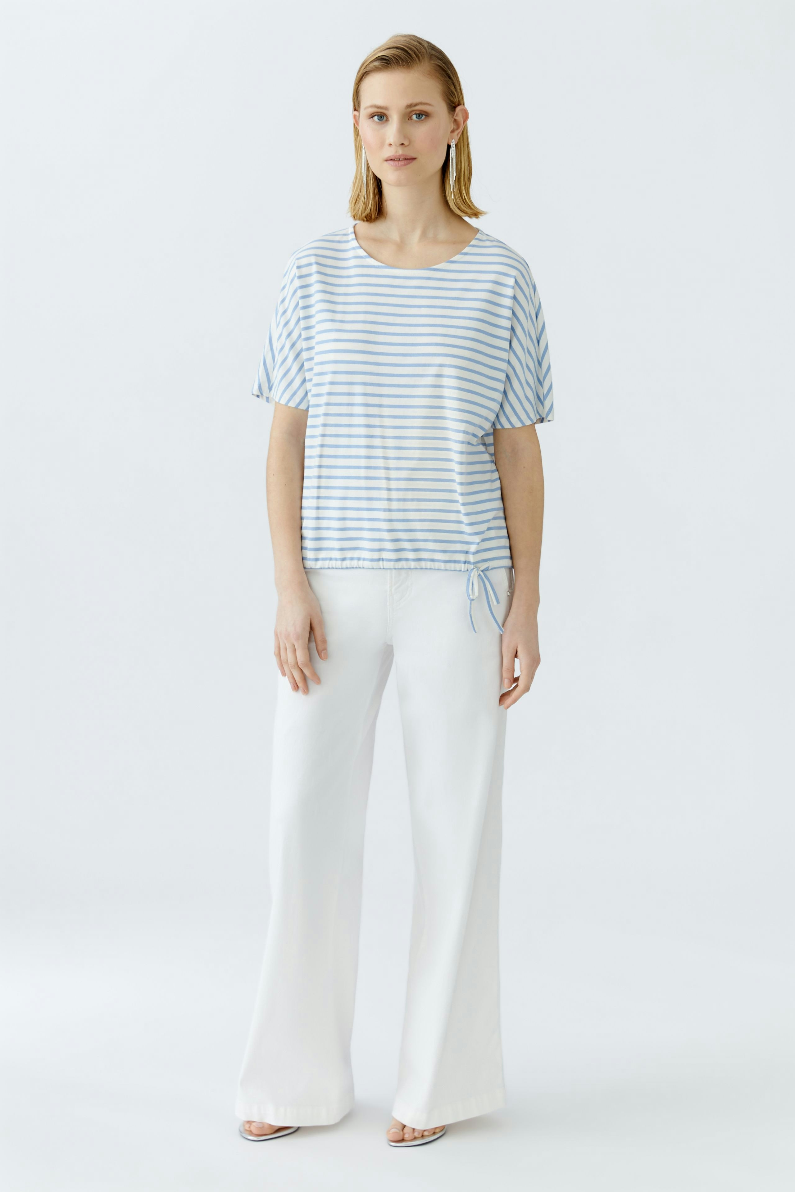 Casual women's T-shirt: Young woman in a striped blue and white tee with a relaxed fit.