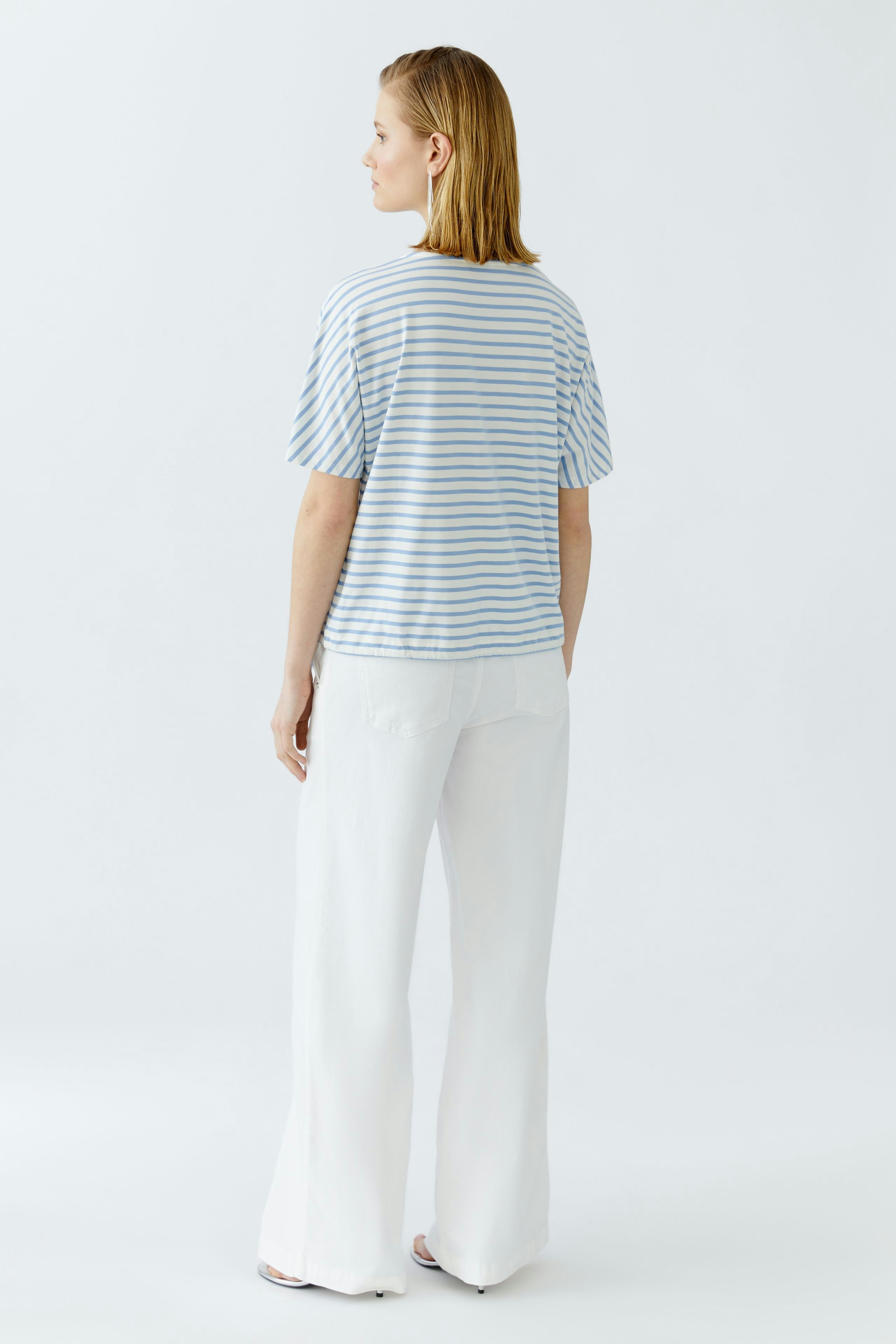 Casual women's T-shirt: A woman in a striped tee with short sleeves and relaxed fit.
