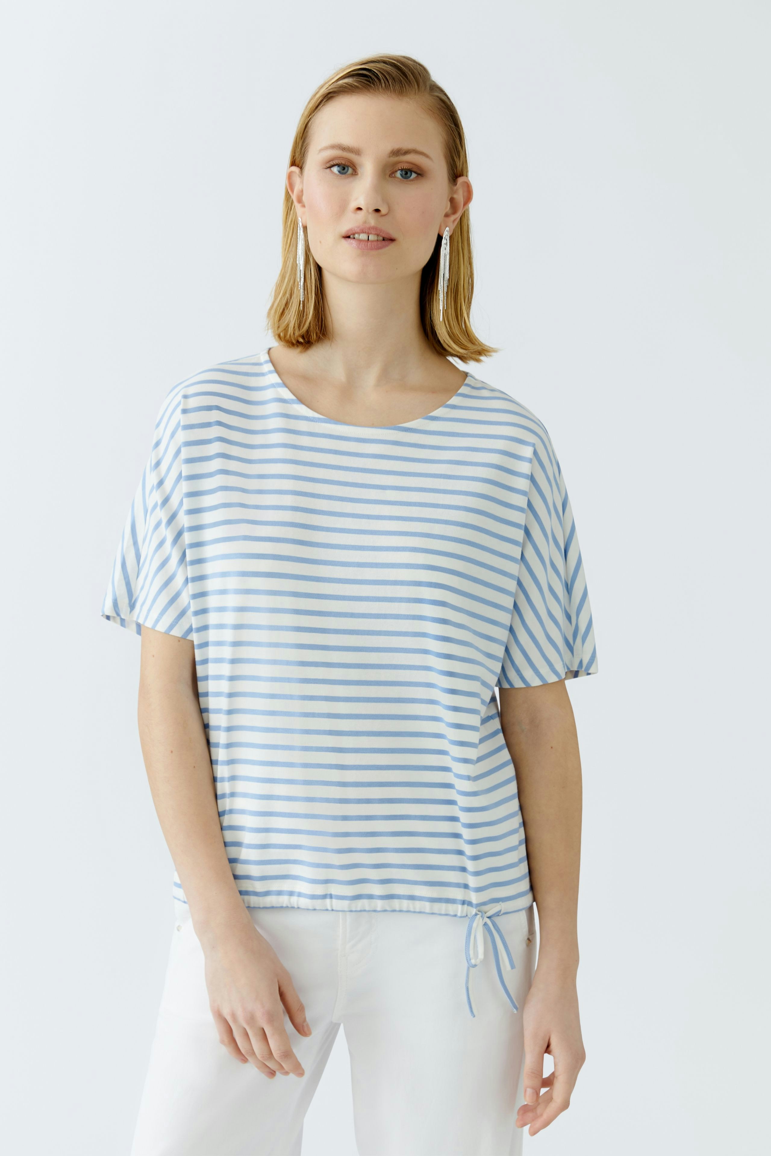 Casual women's T-shirt: A woman in a light blue striped tee with a relaxed fit and drawstring detail.