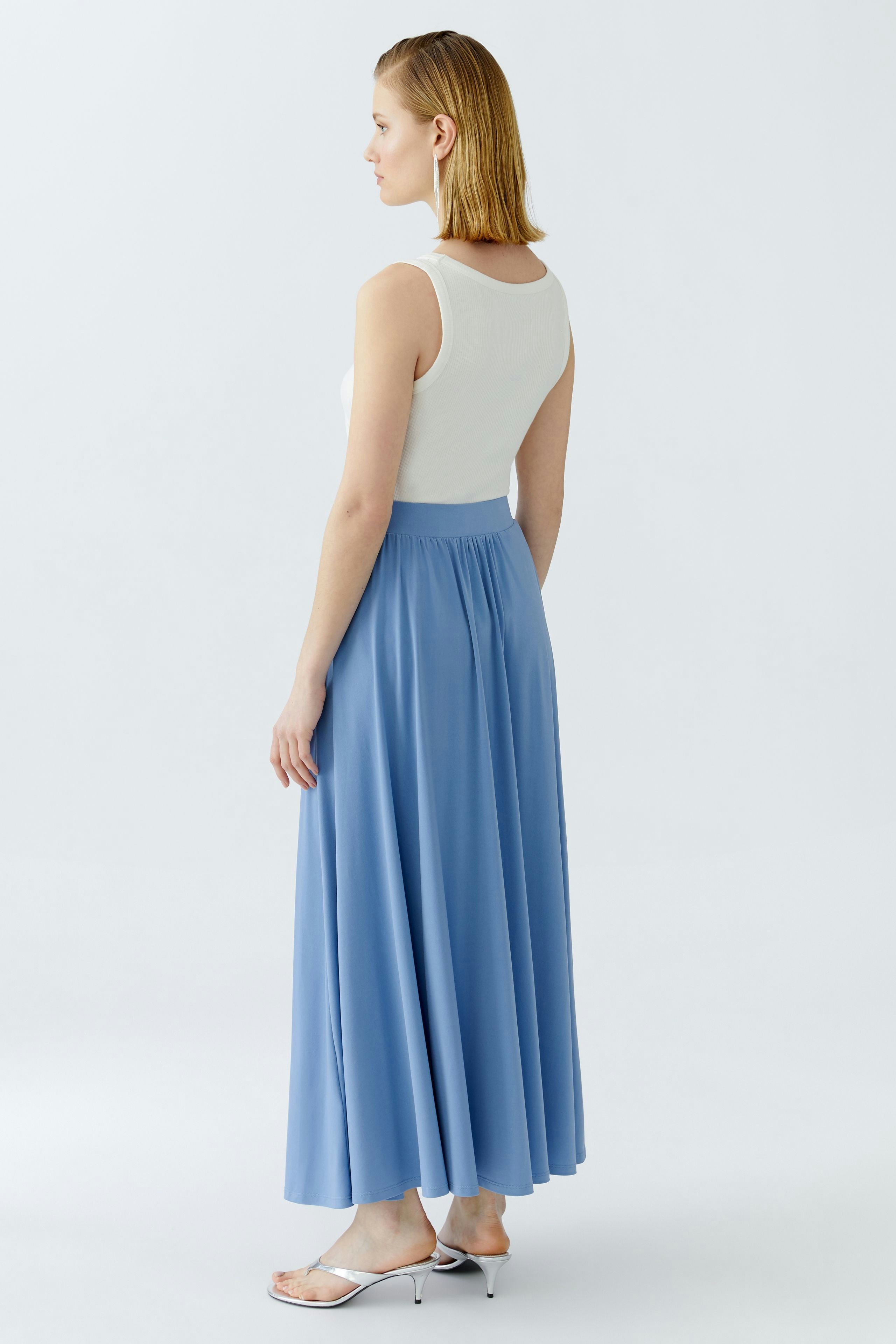 A-Linien-Rock: Frau in einem blauen, fließenden Rock mit elastischem Bund von Oui.