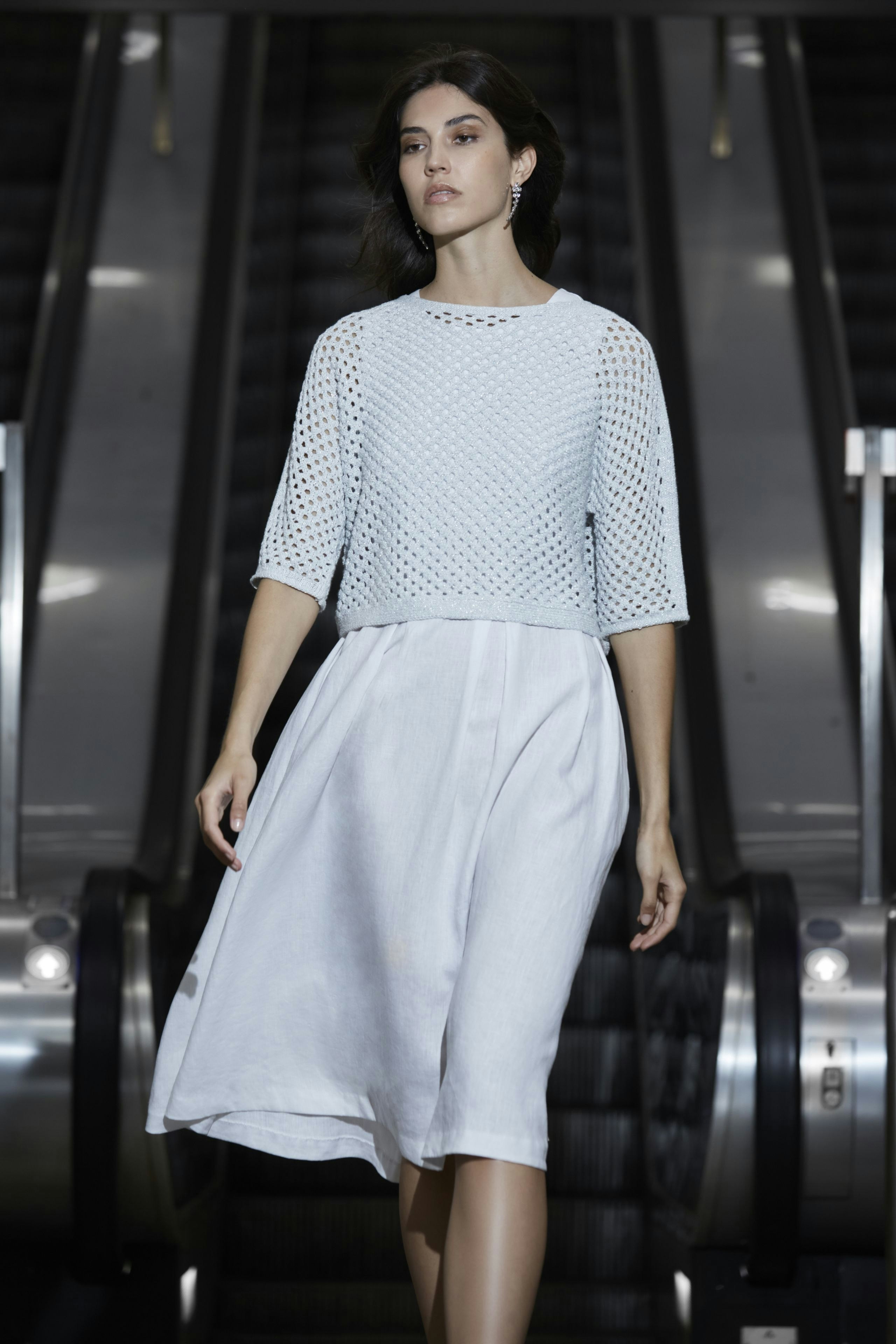 Lightweight midi dress: Woman in a relaxed, flowing white dress with a textured blue top.