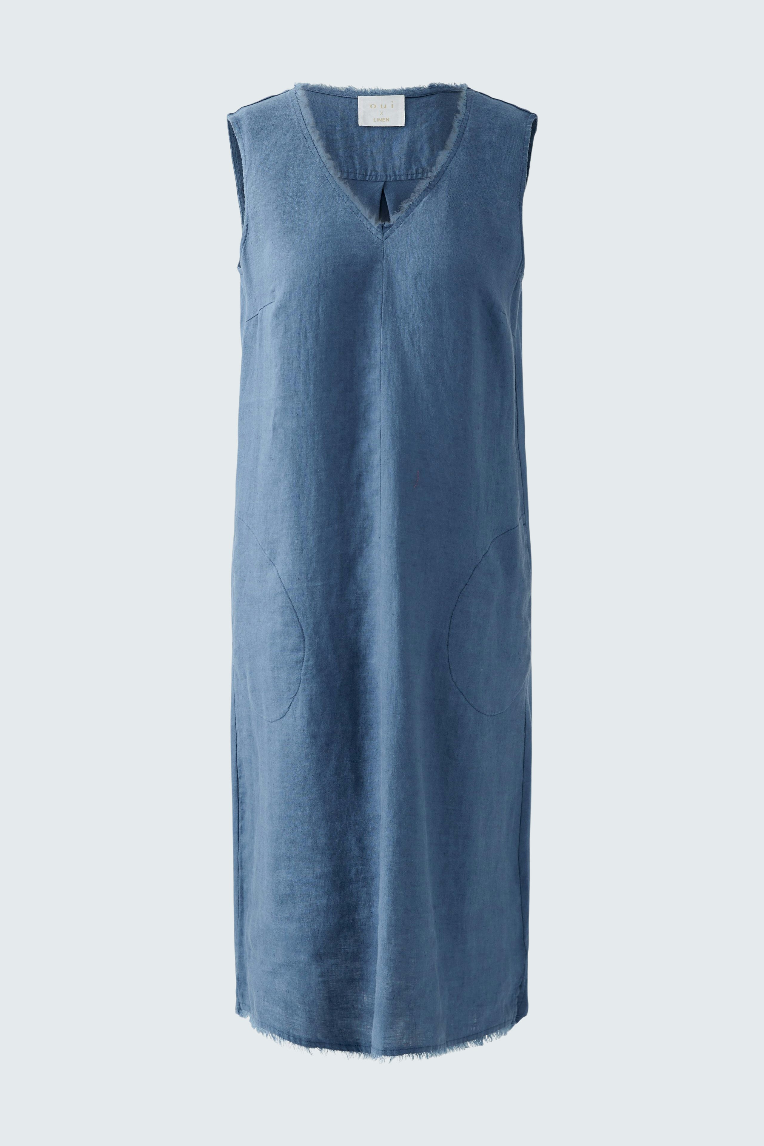 Casual A-line dress: A woman in a sleeveless blue dress with a V-neck and side pockets.