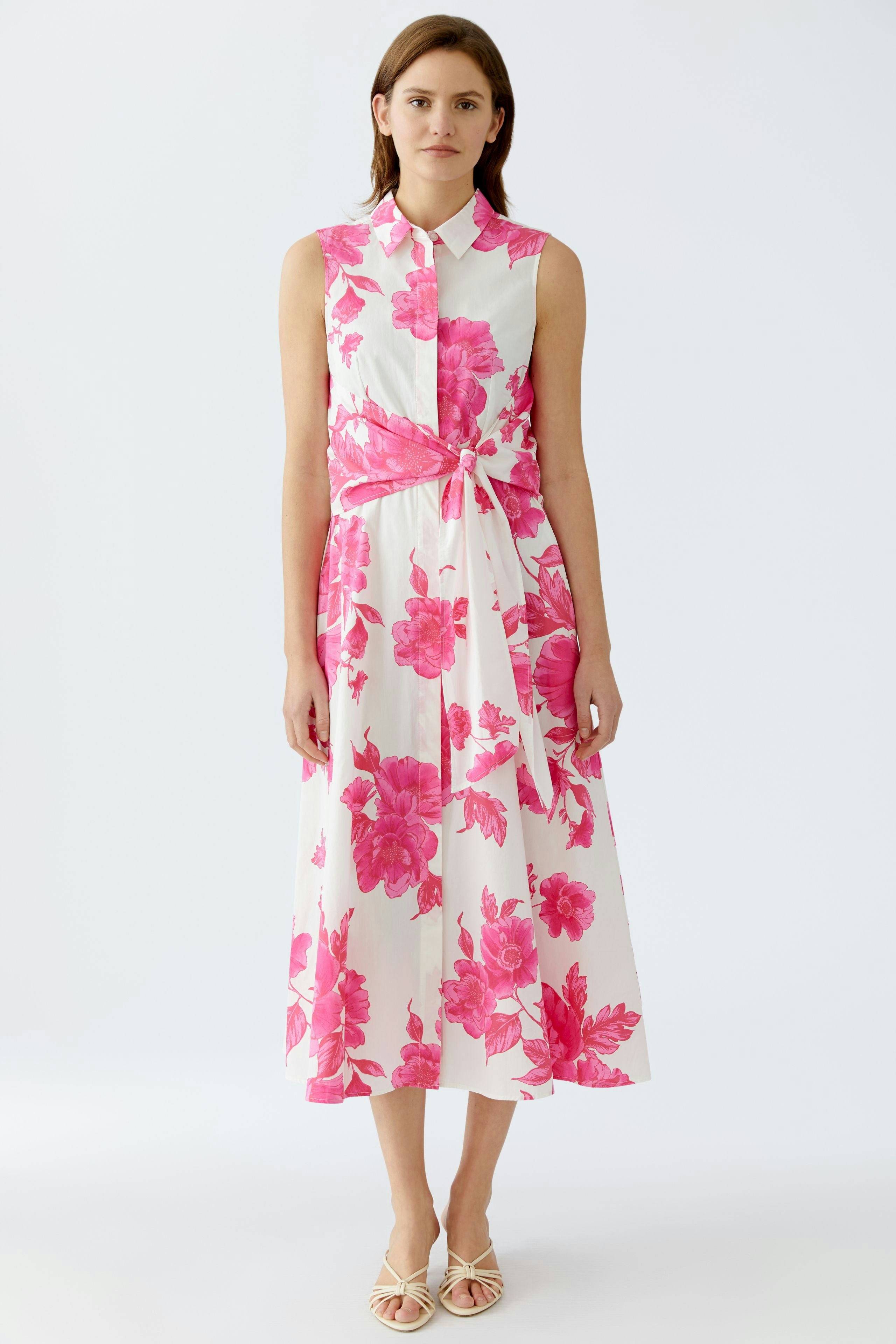Elegant maxi dress: A woman in a floral print dress with a tied waist, perfect for summer occasions.