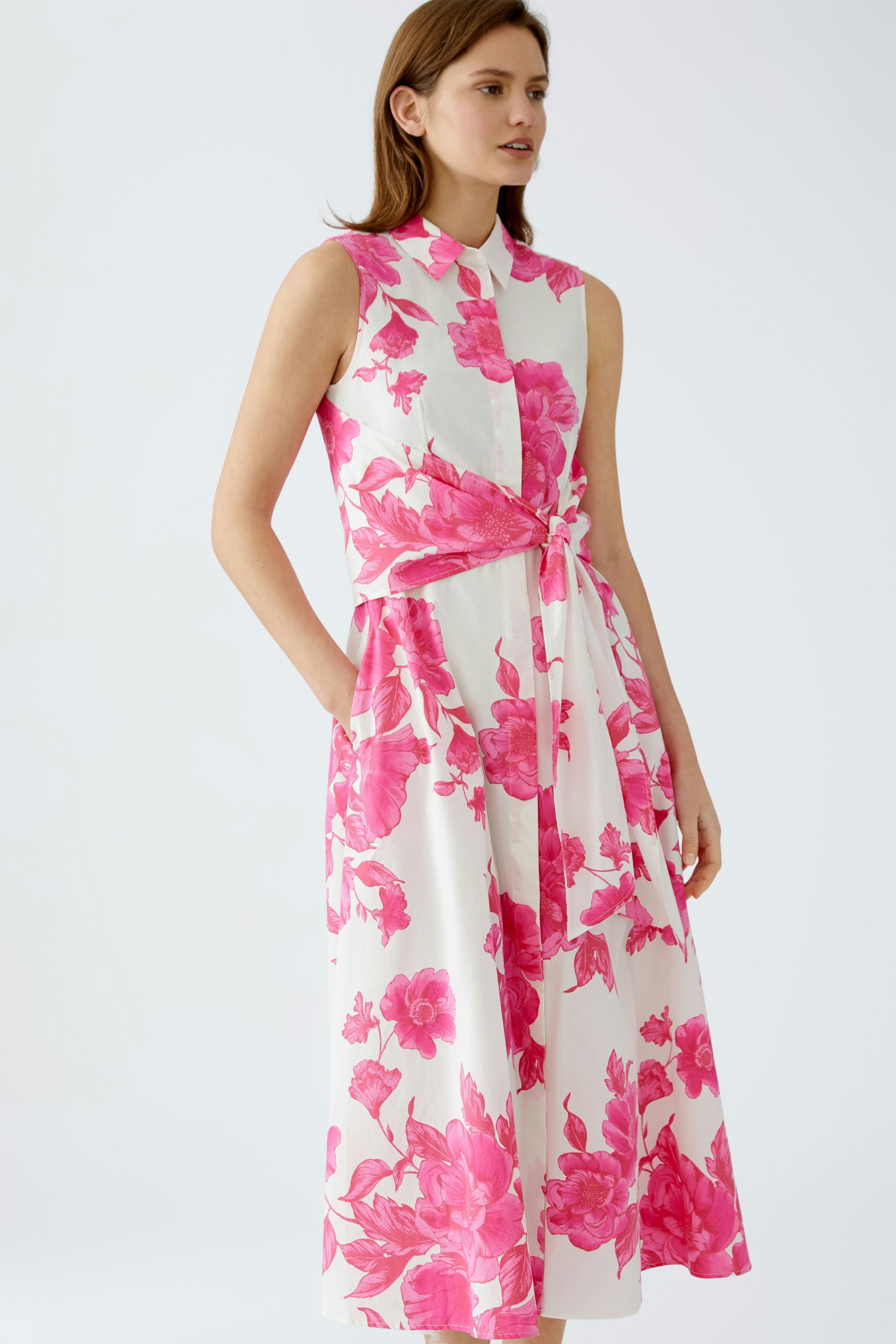 Elegant maxi dress: A woman in a floral print dress with a tied waist, perfect for summer occasions.