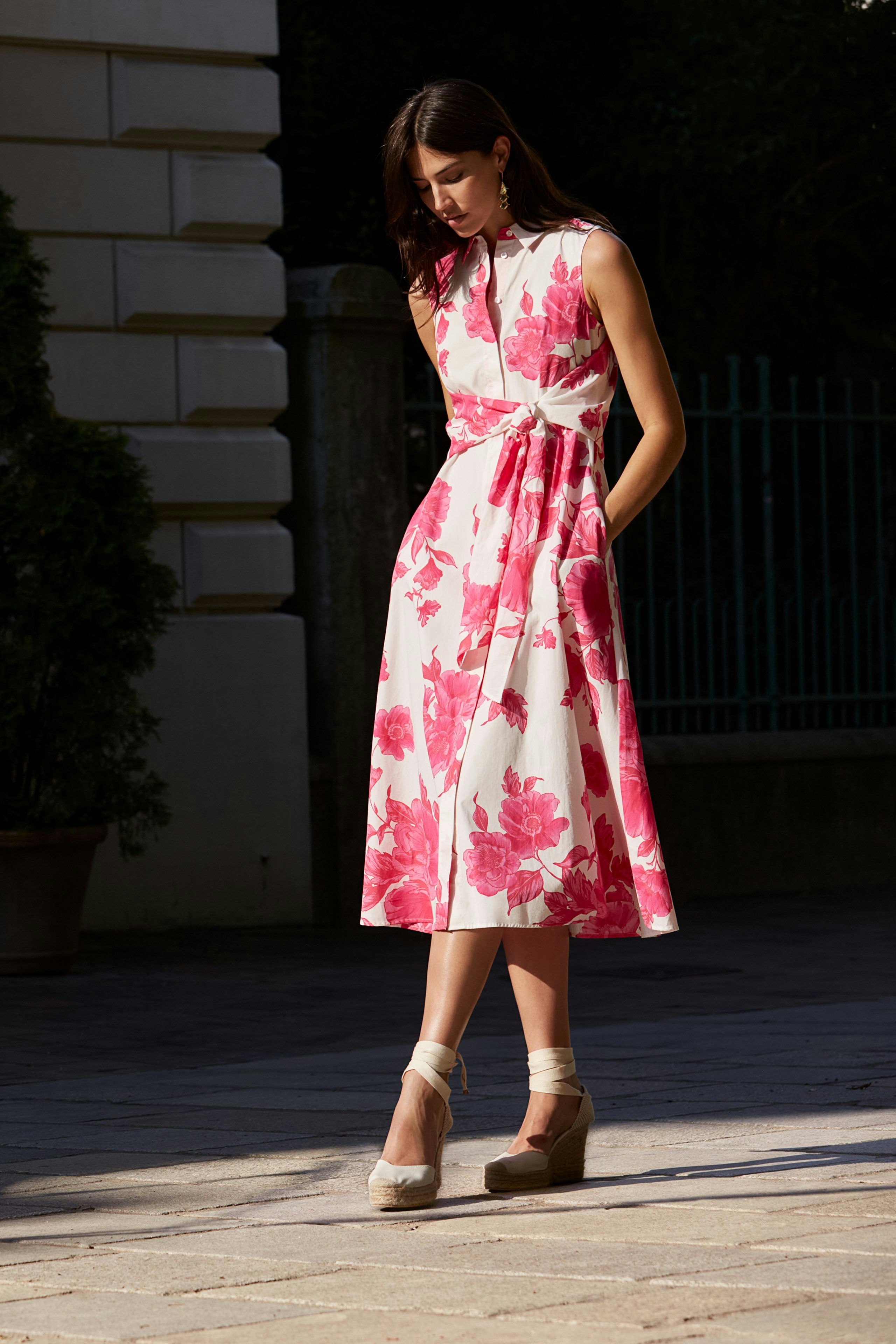 Elegant maxi dress: A woman in a floral print dress with a fitted waist and flowing skirt.