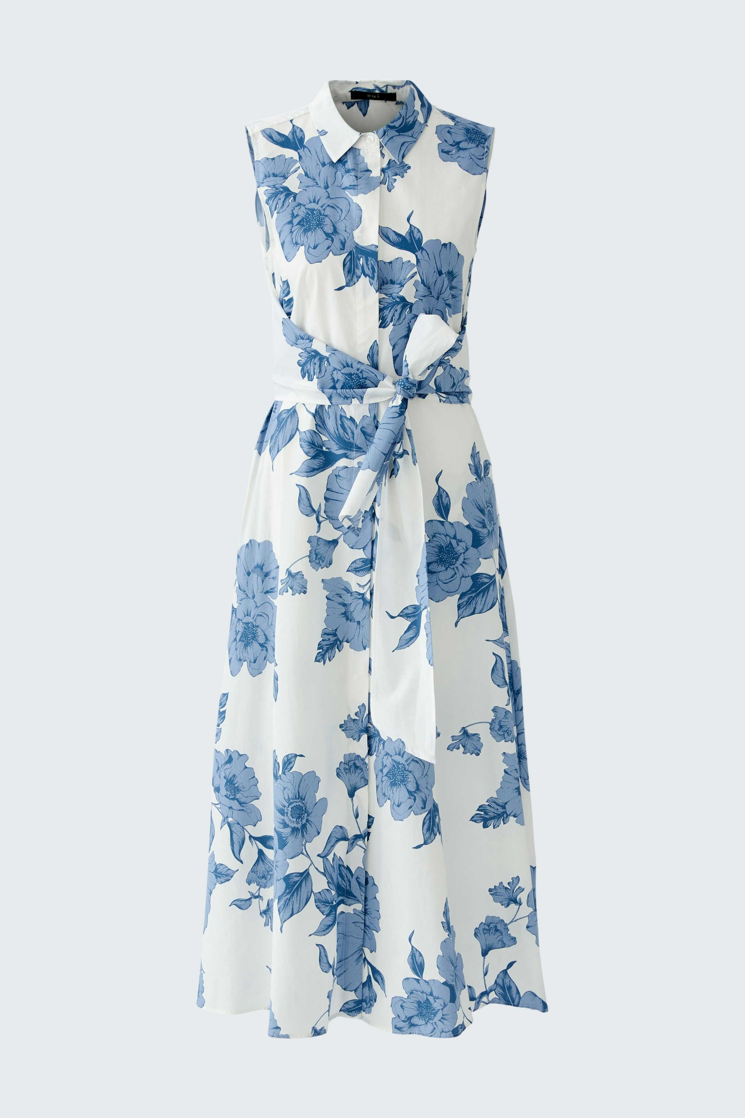 Elegant maxi dress: A woman in a floral print dress with a fitted waist and flowing skirt.