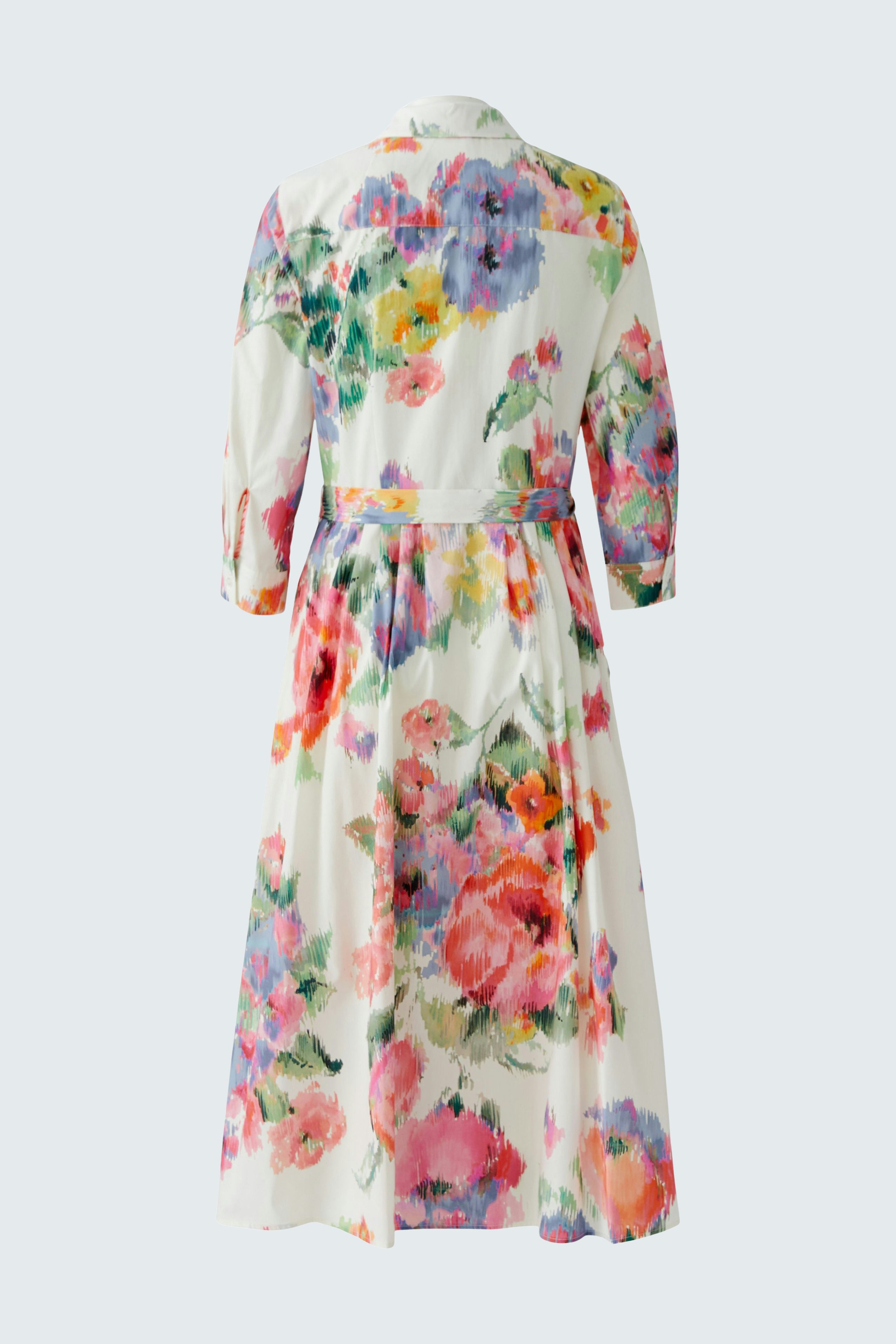 Floral midi dress: A woman in a colorful floral dress with three-quarter sleeves and a tied waist.
